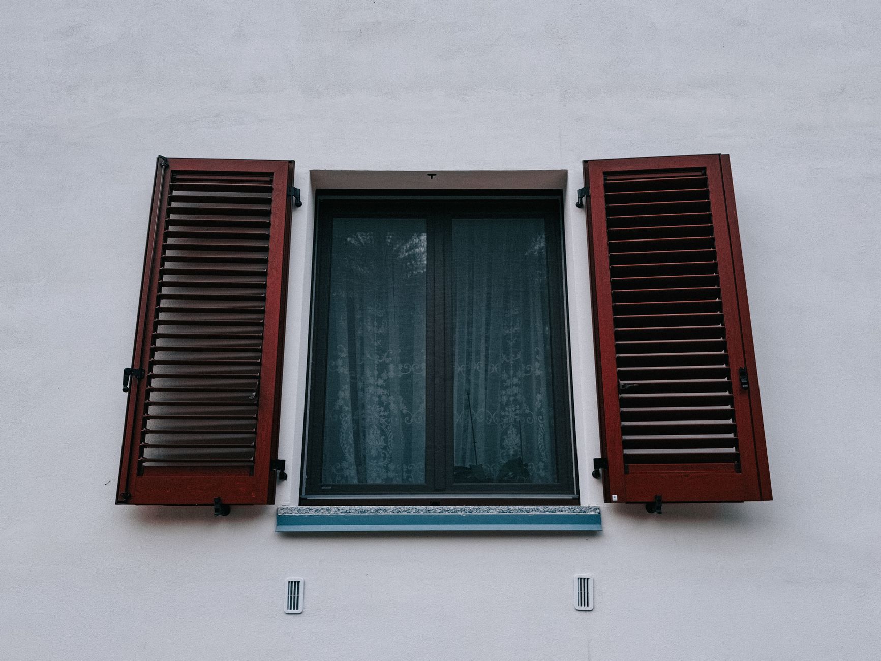 A window with red shutters