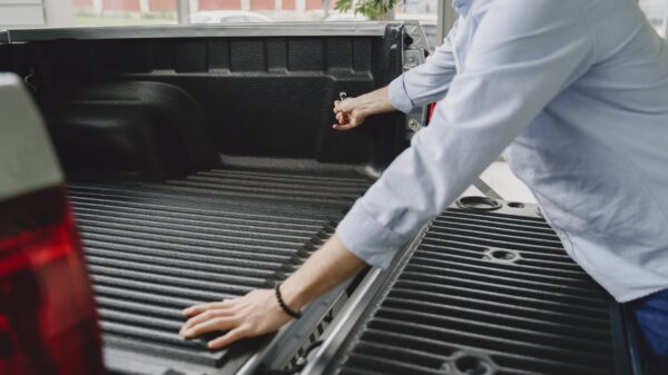 Best ratchet straps: a man opening a pickup truck tailgate