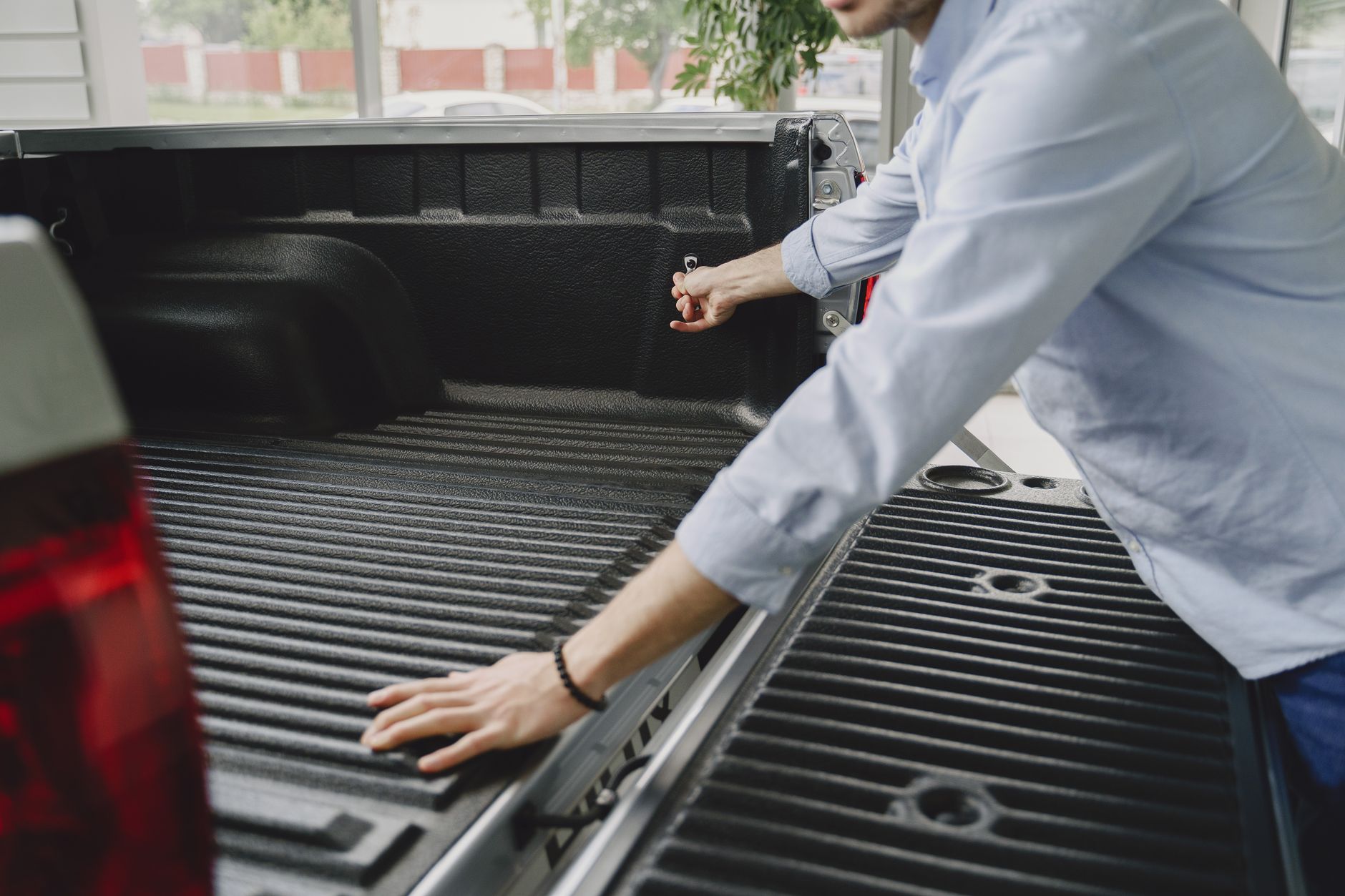 Best ratchet straps: a man opening a pickup truck tailgate