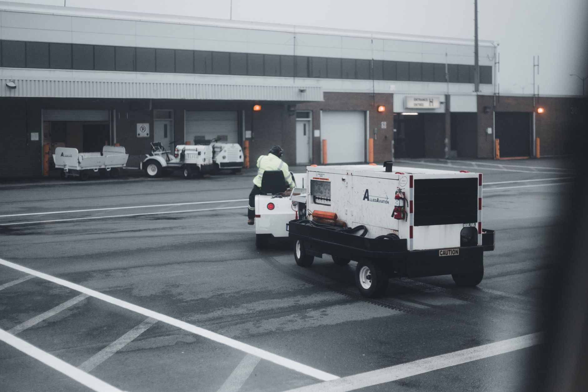 A utility cart towing equipment in a parking lot