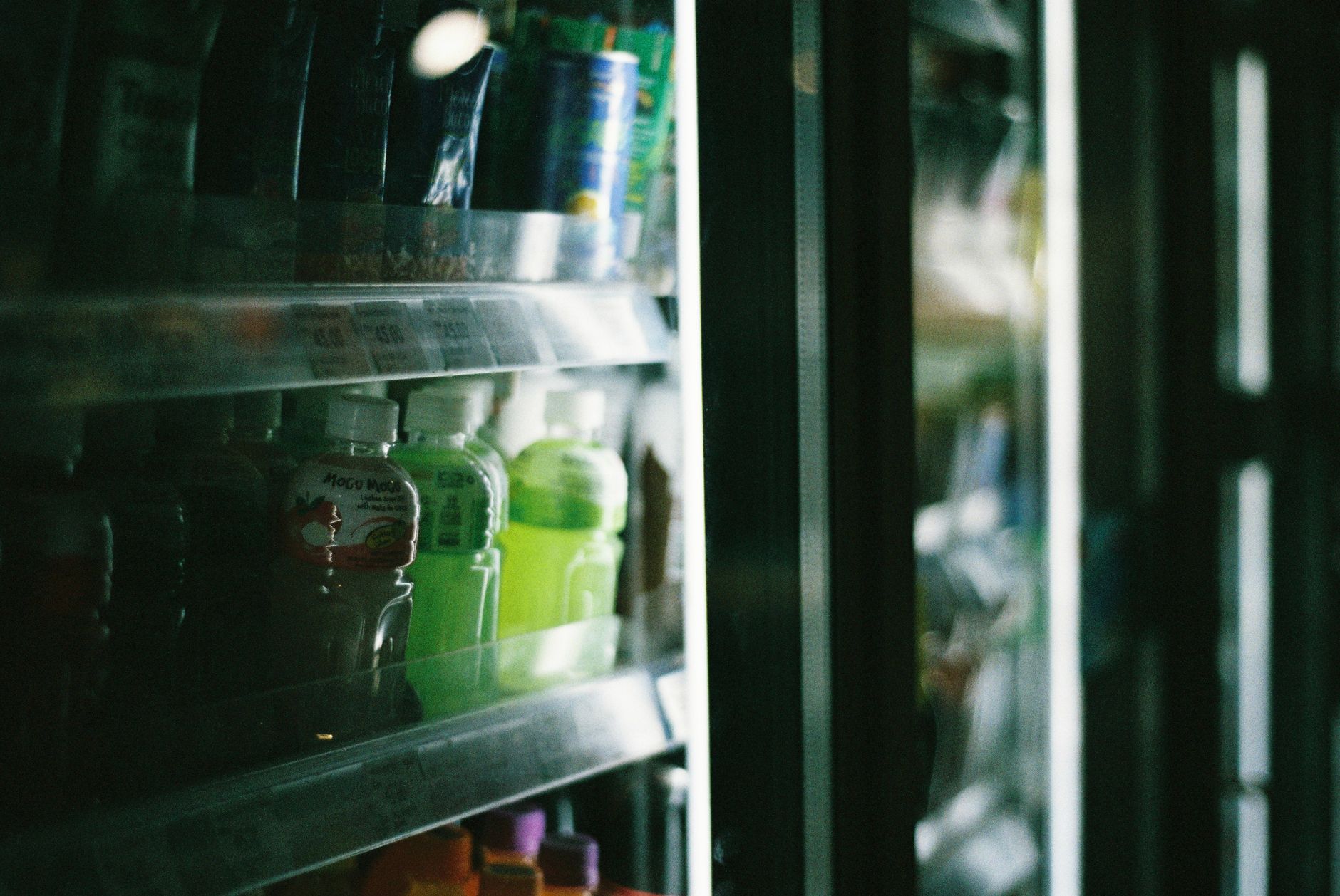 Bottled drinks on refrigerator shelves