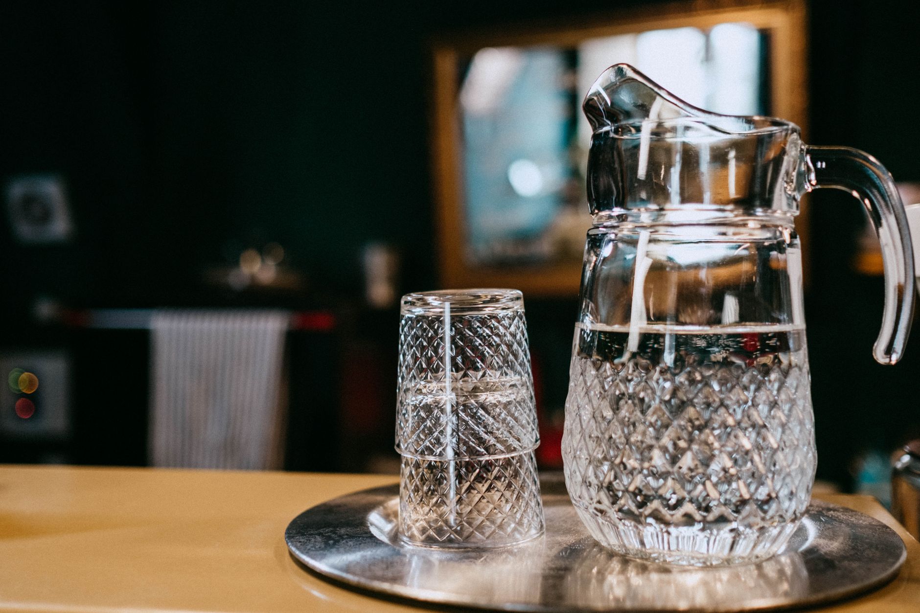 A crystal water pitcher and glass