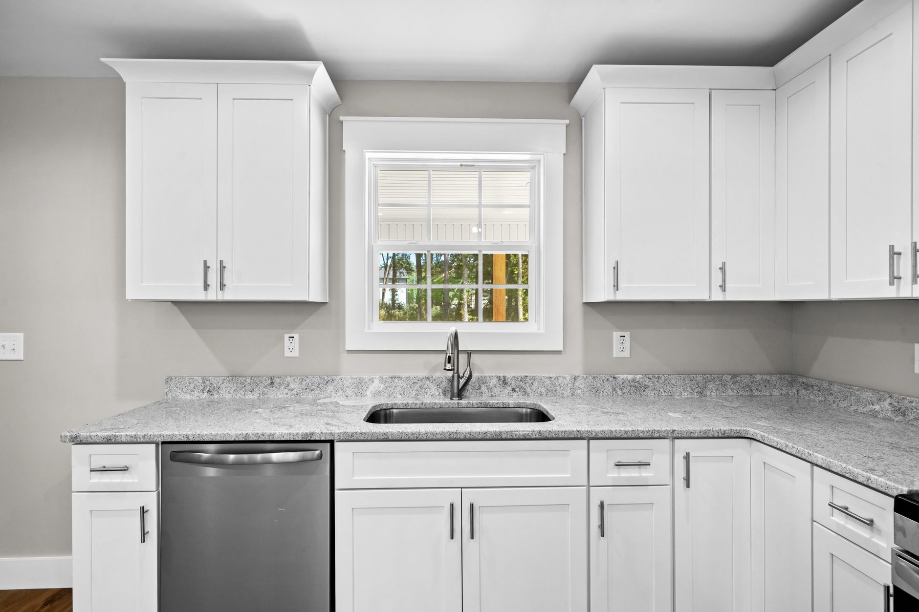 A kitchen sink below a window