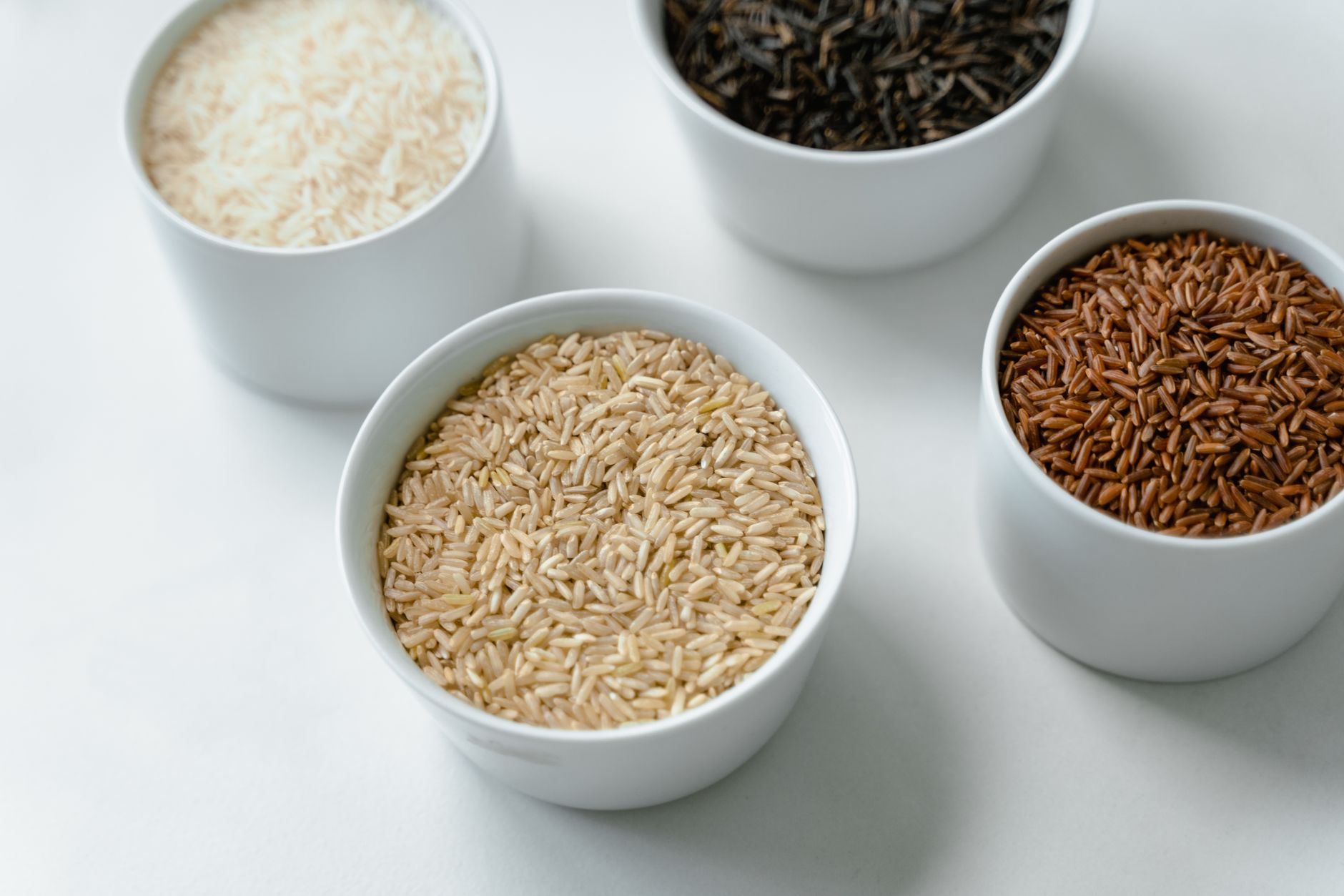Bowls of white, brown, wild and red rice