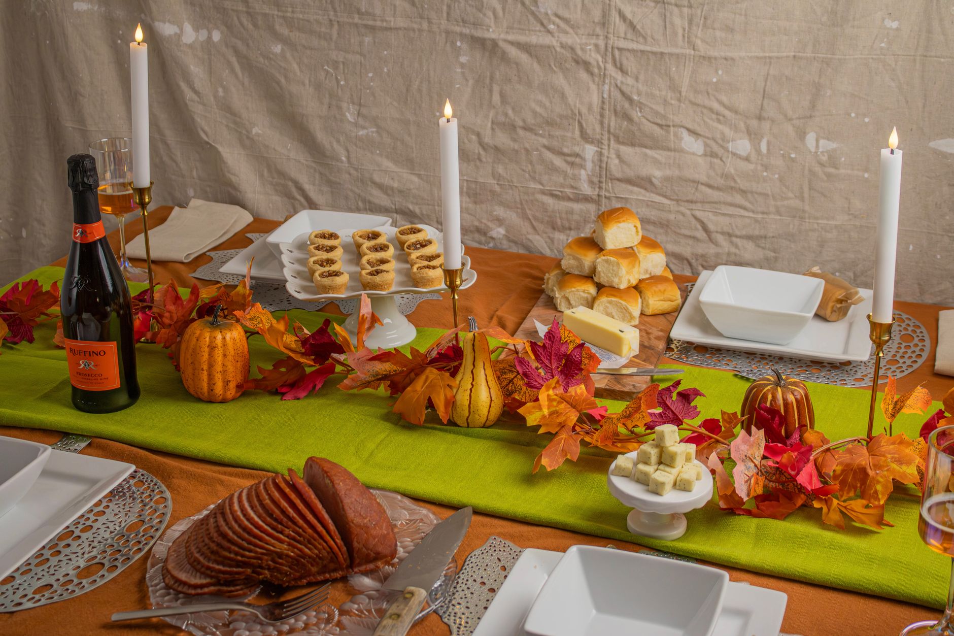 A fall table set with candles and food