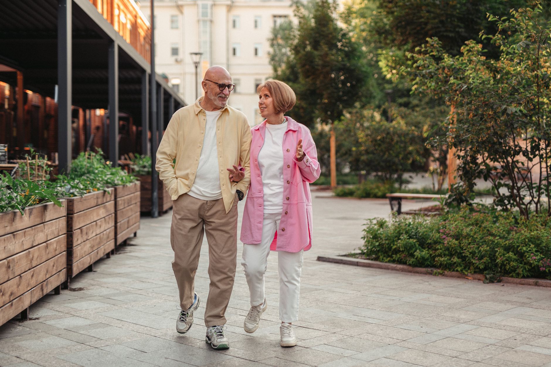 An older adult walking on a sidewalk
