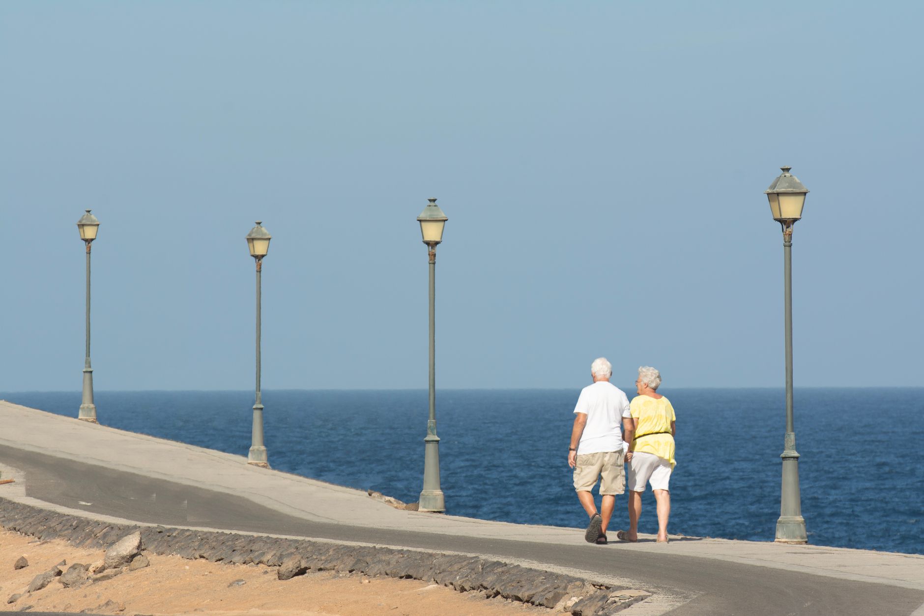 Two older adults walking together outdoors
