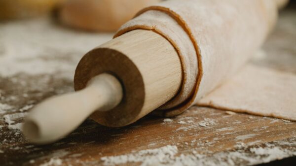 Best rolling pin: a wooden rolling pin on a floured counter