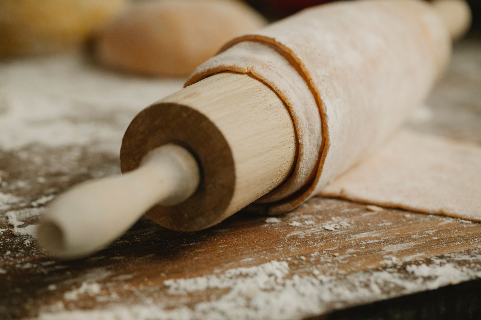 Best rolling pin: a wooden rolling pin on a floured counter