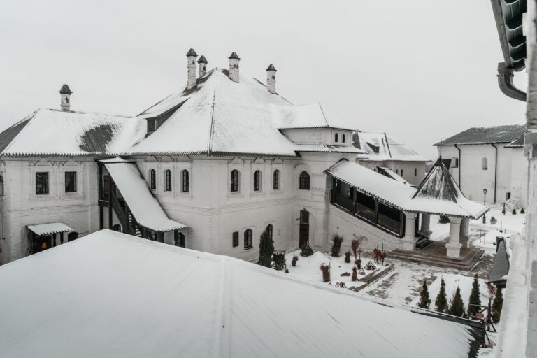 Snow covering the roofs of a large white building