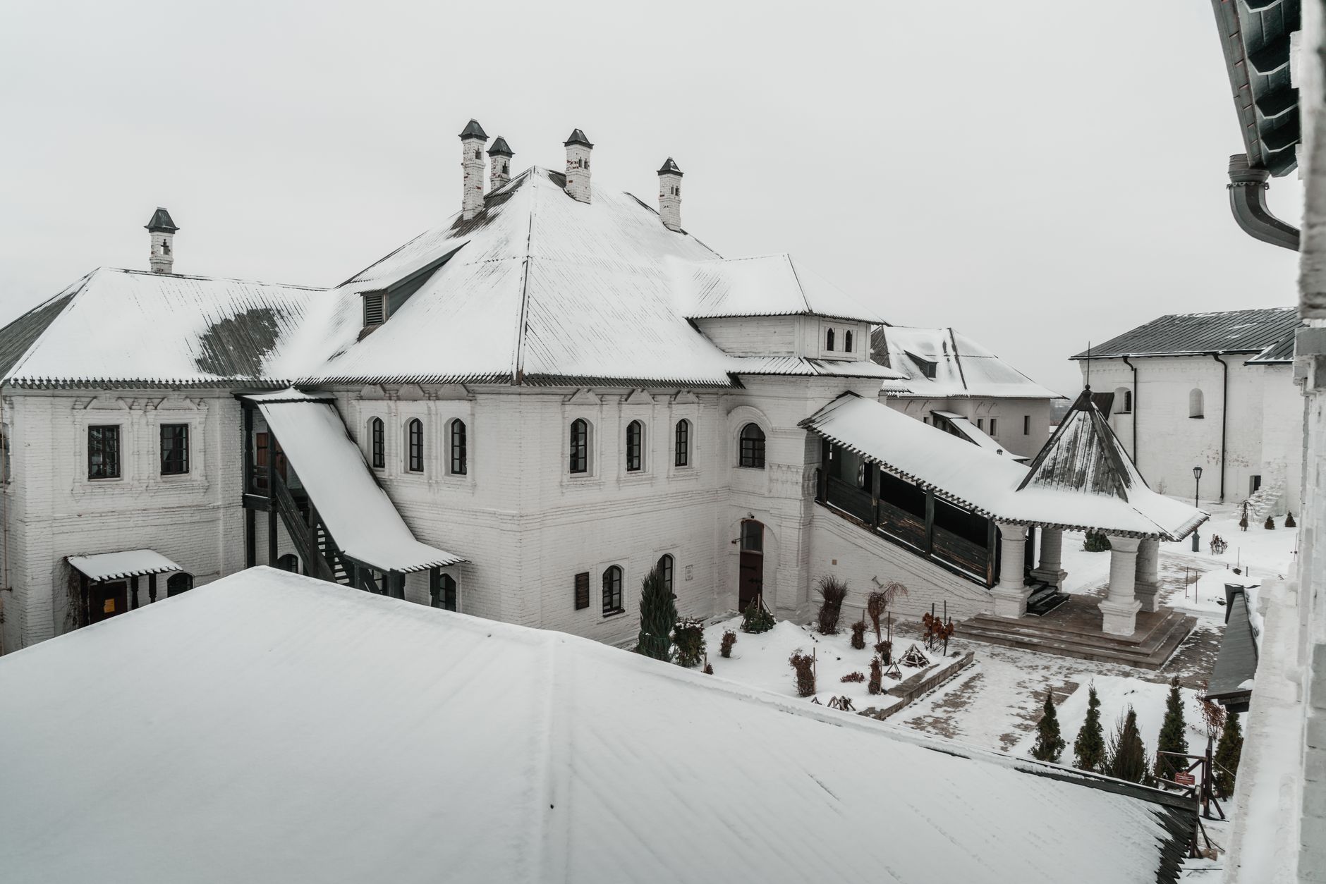 Snow covering the roofs of a large white building
