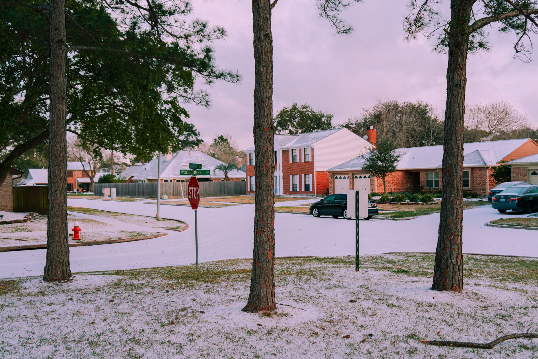 A light snowfall on a residential street with houses