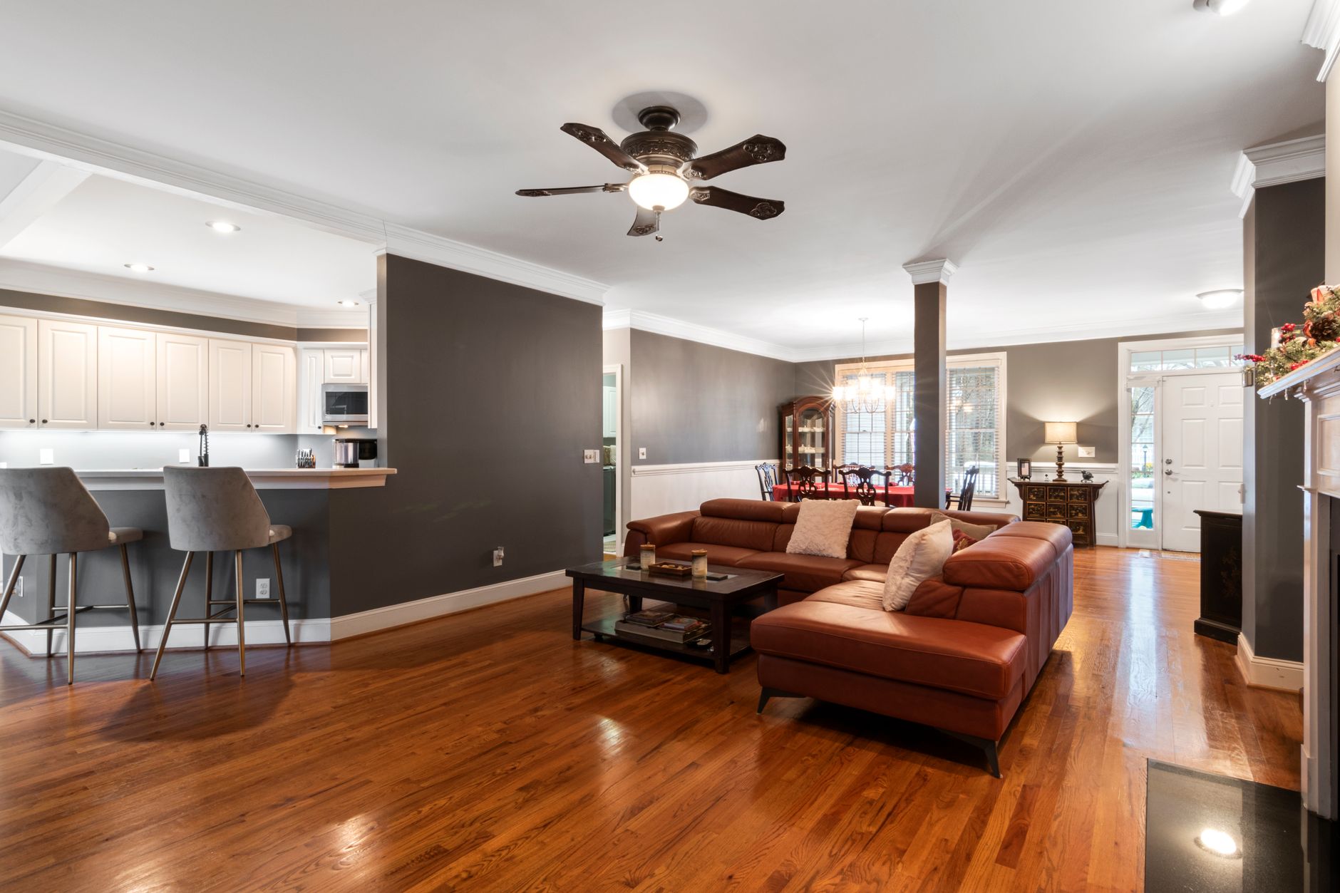 A living room with a wood floor and an area rug