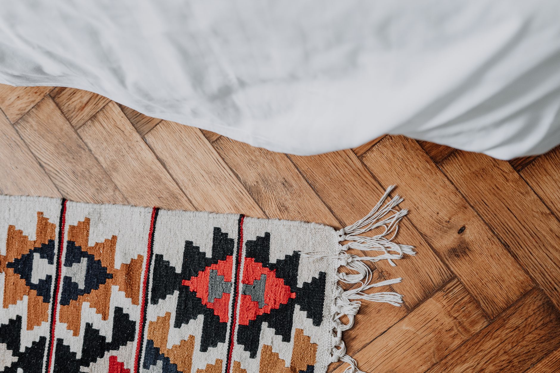 A woven rug on a wooden floor