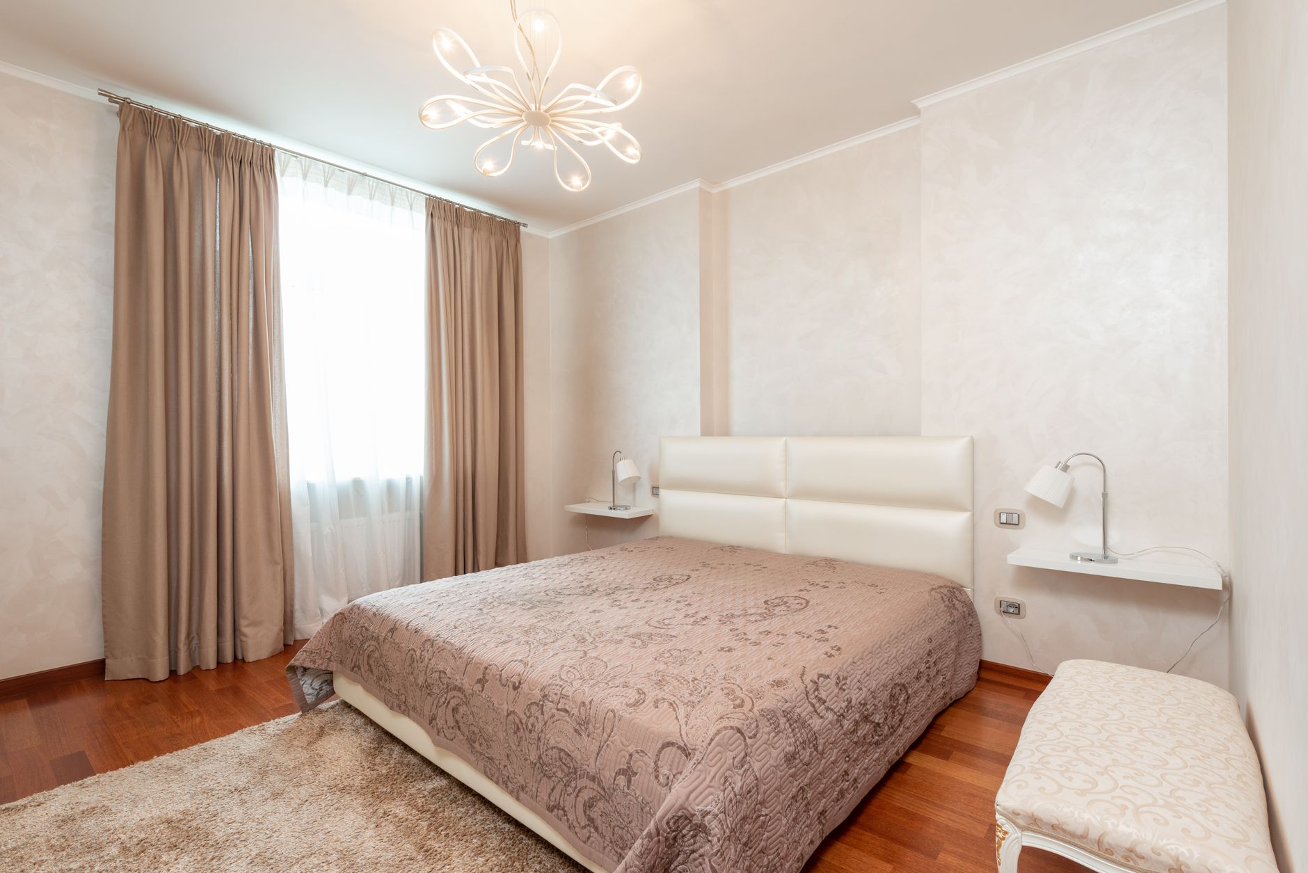 A soft rug beside a bed in a cozy bedroom
