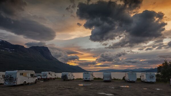 Motorhomes parked at a campground under storm clouds