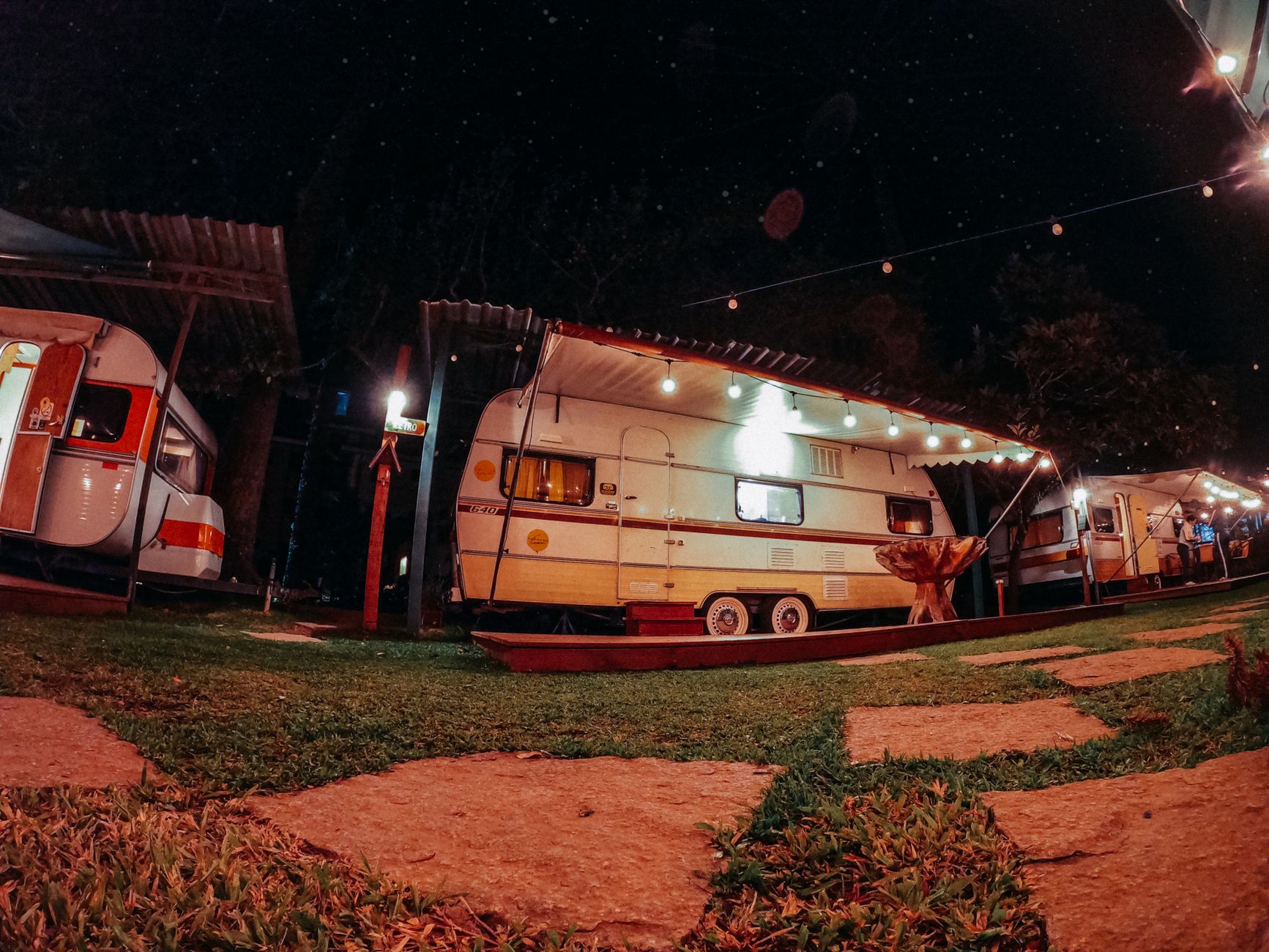 Camper trailers lit up at night
