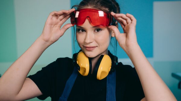 Best safety glasses: a woman putting on protective goggles