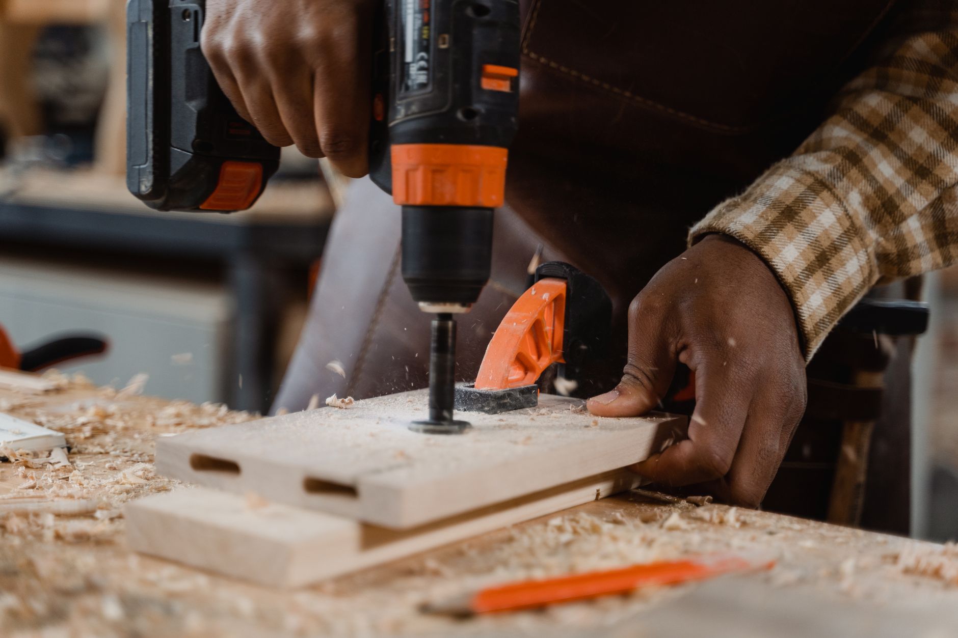 Drilling into a board on a workbench