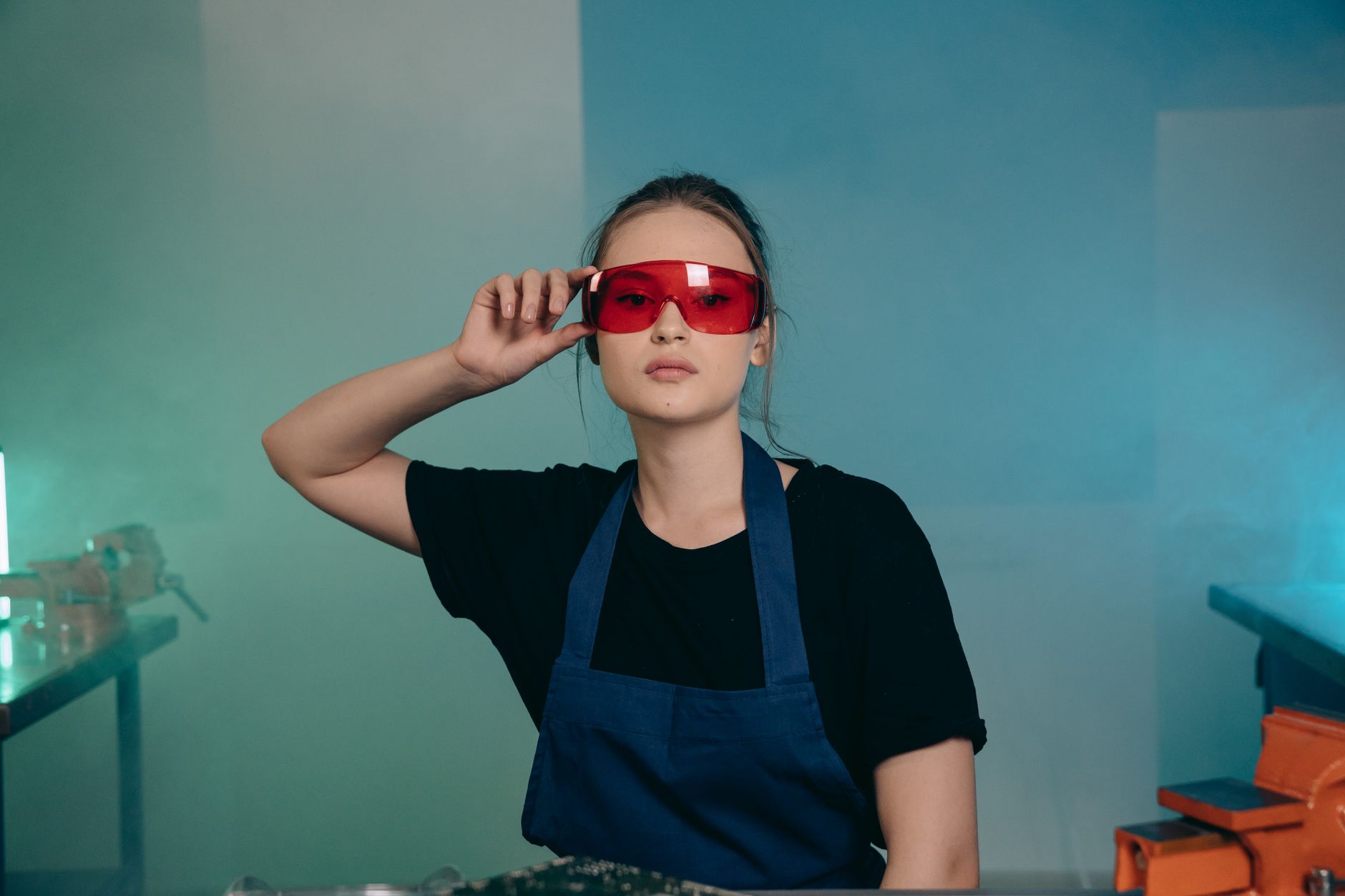 A person wearing safety glasses in a workshop