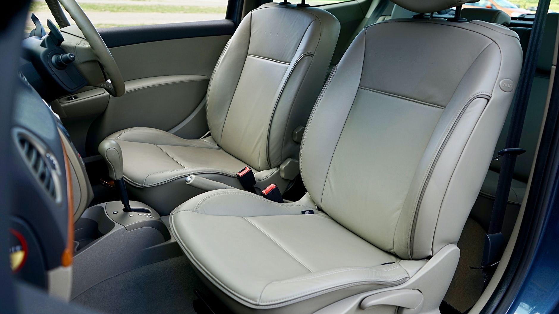 Best car seat gap filler: front seats and center console of a car