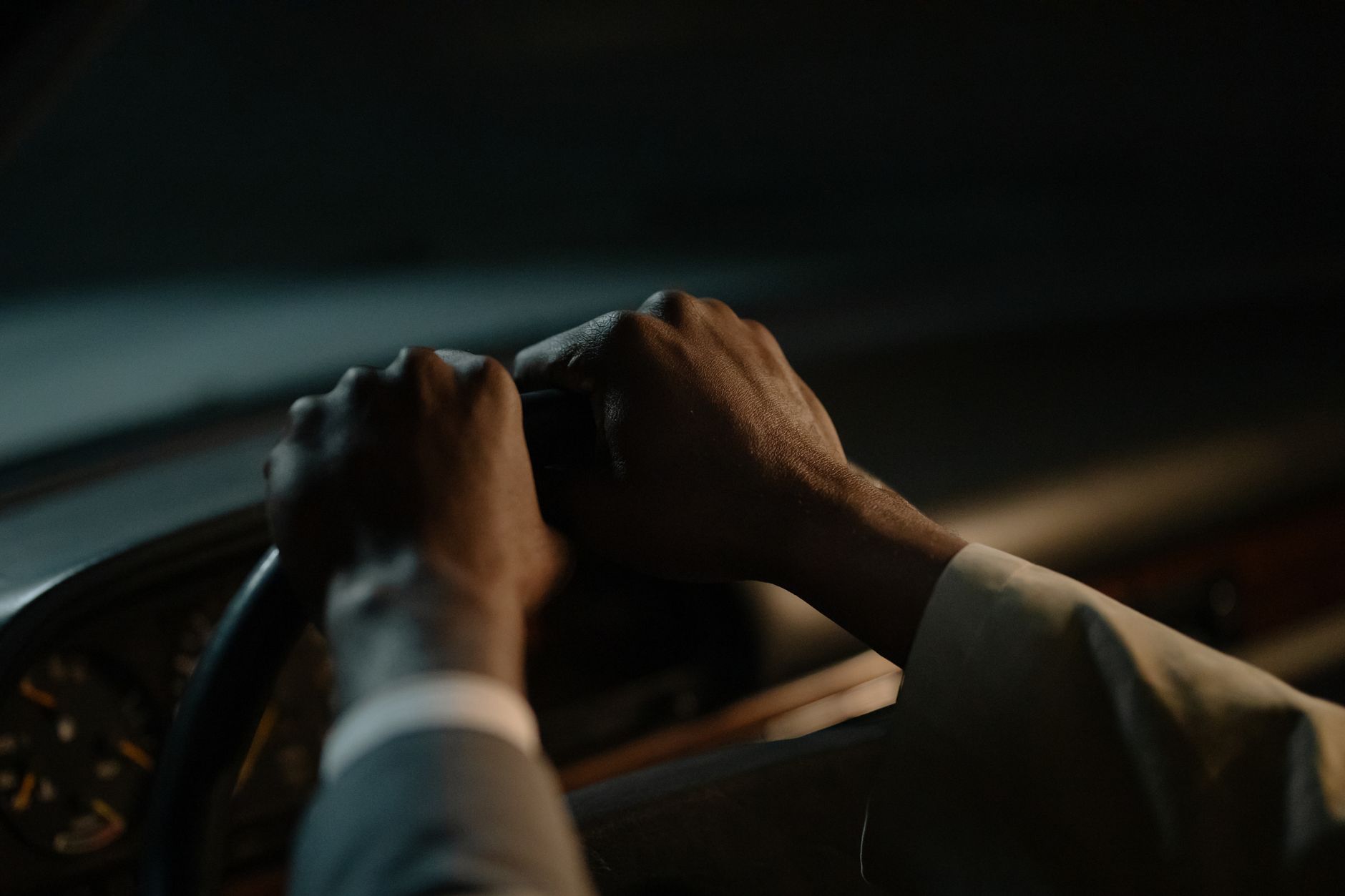 A driver with both hands on the steering wheel