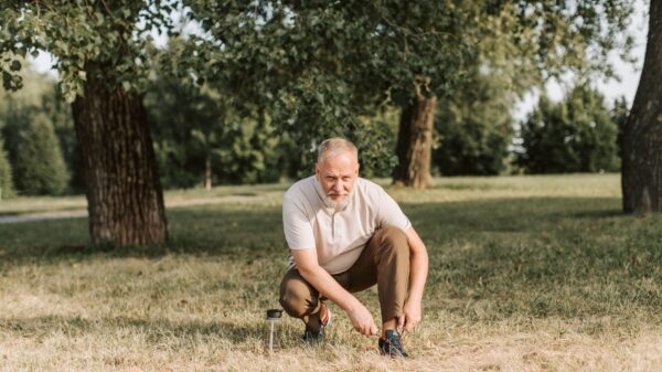 Best long handled shoe horn: an older man tying his shoe outdoors