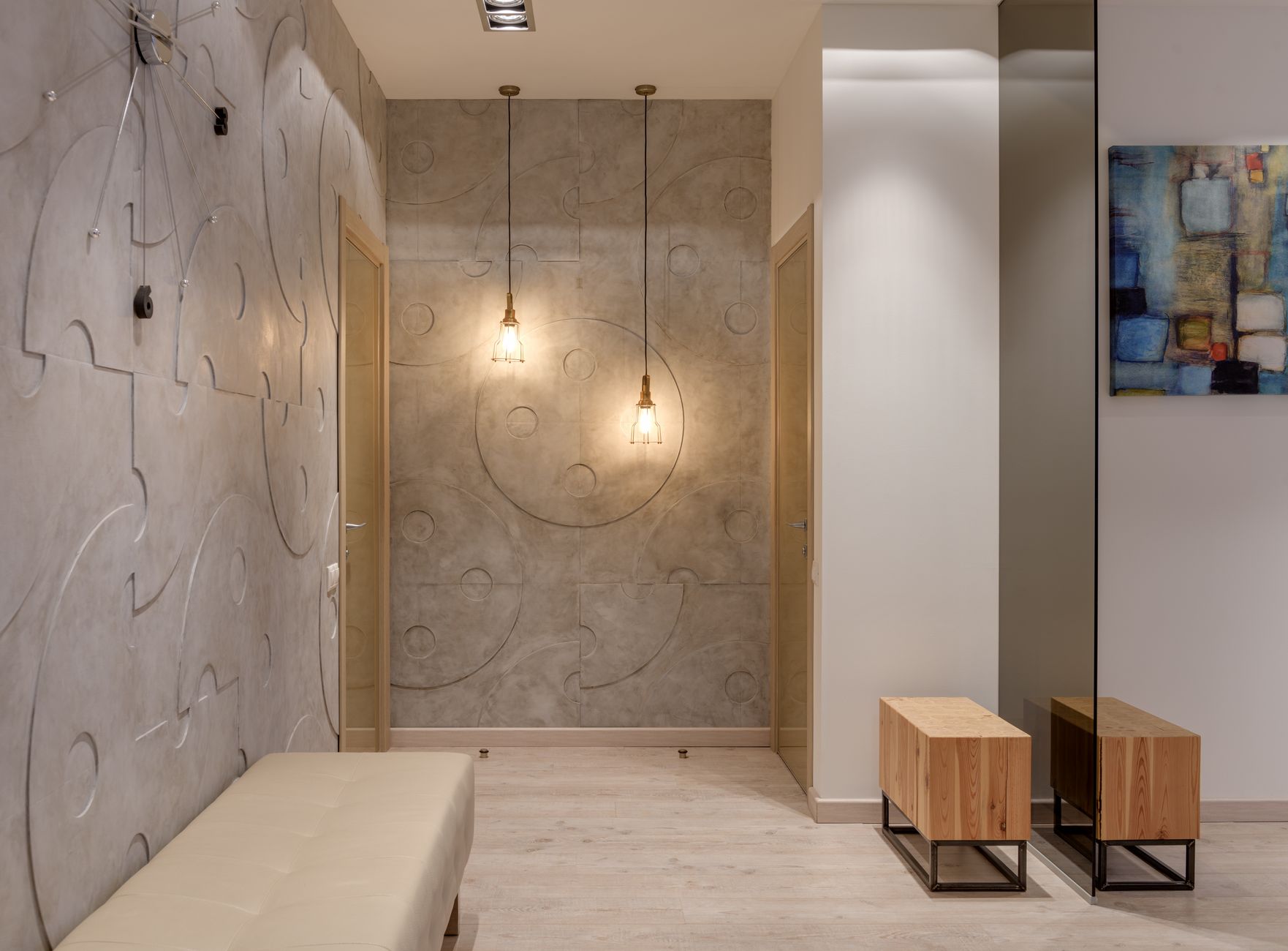 An entryway with a bench and pendant lights