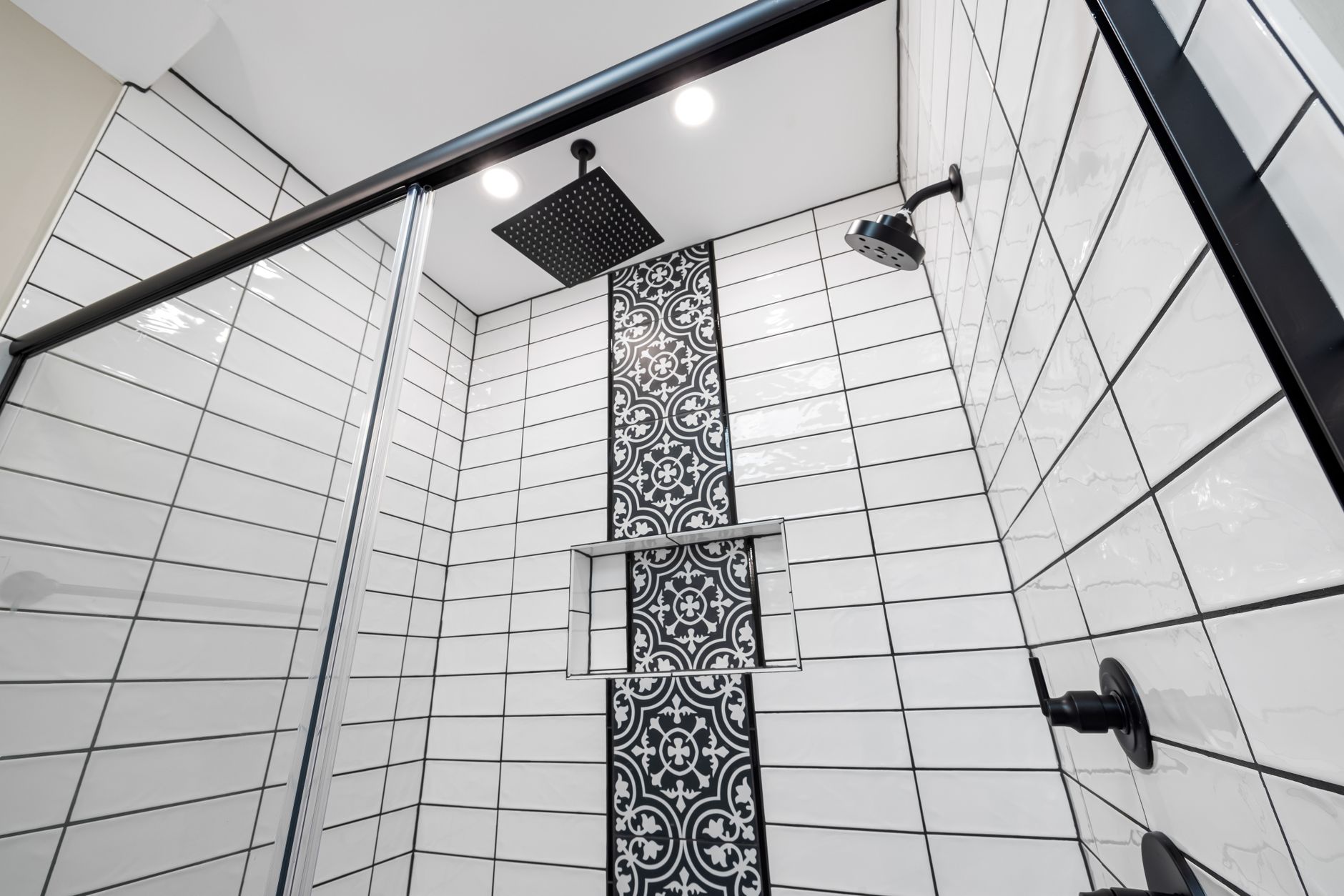 Best shower caddy: a tiled shower with black fixtures