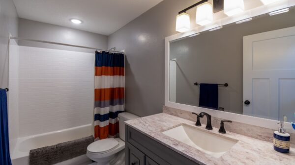 A bathroom with a striped shower curtain