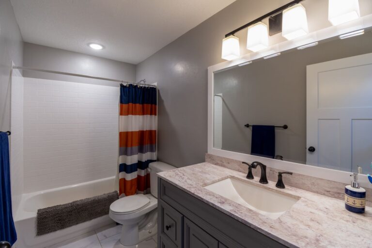 A bathroom with a striped shower curtain