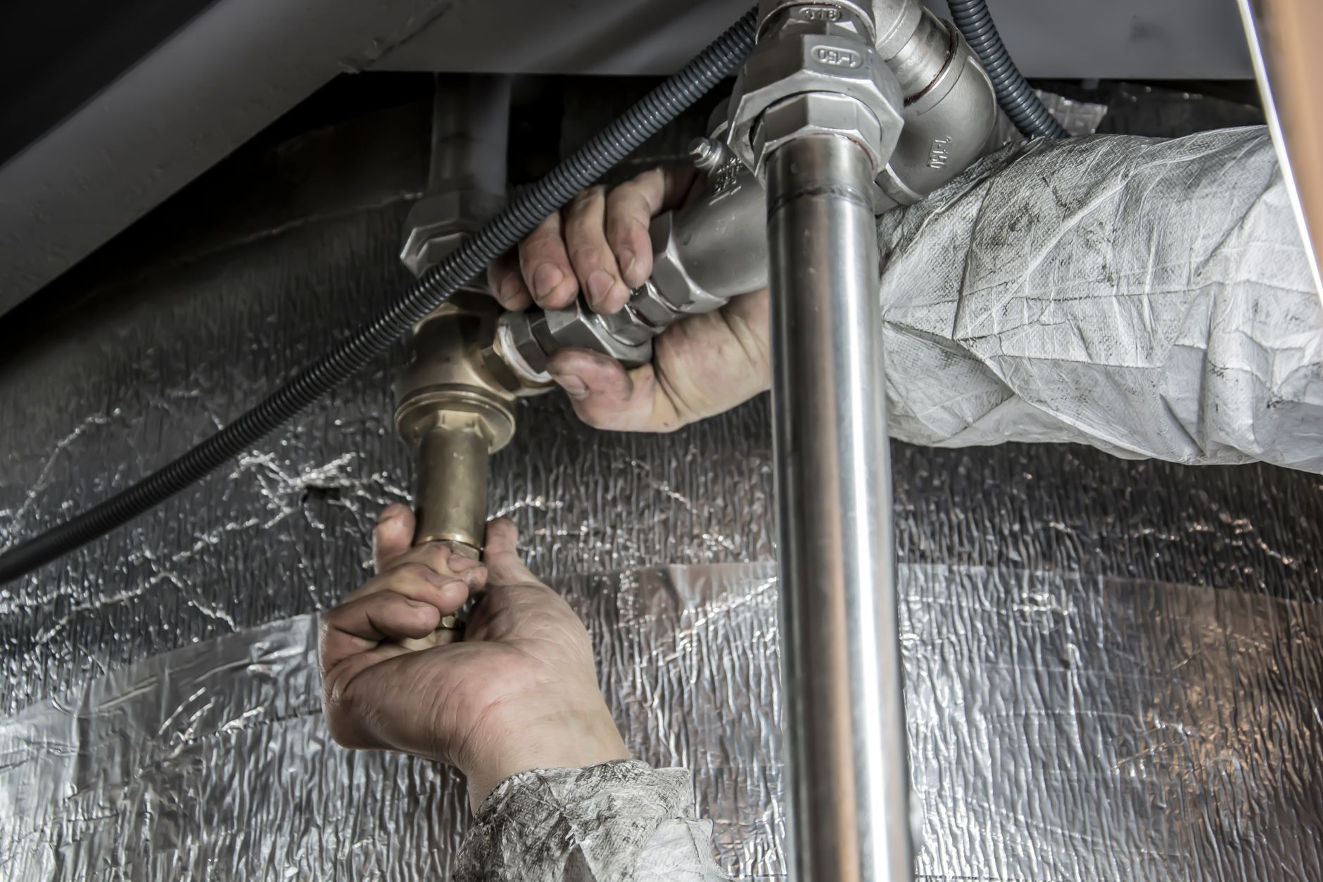 Hands fitting plumbing pipes