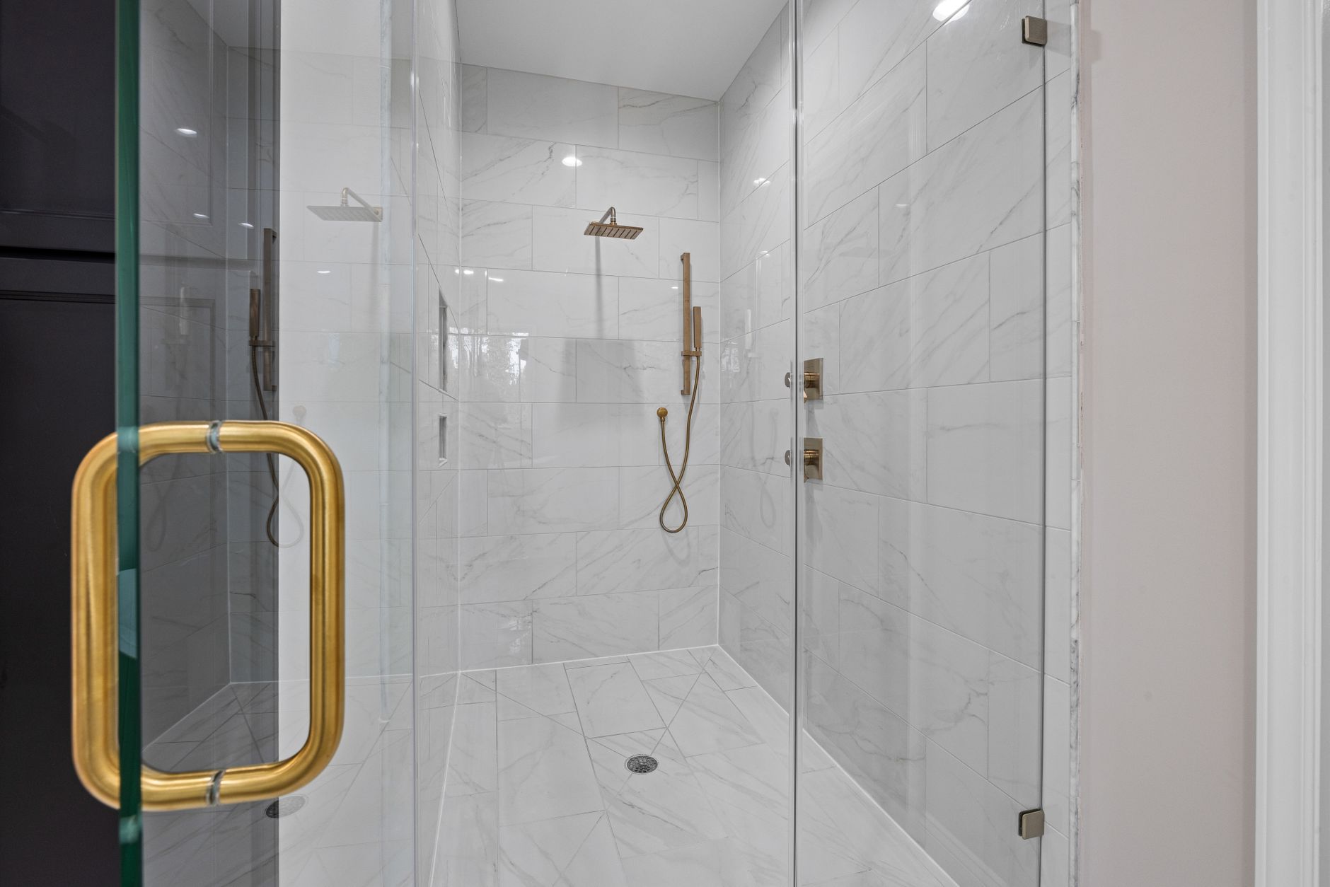 A walk-in shower with a glass door