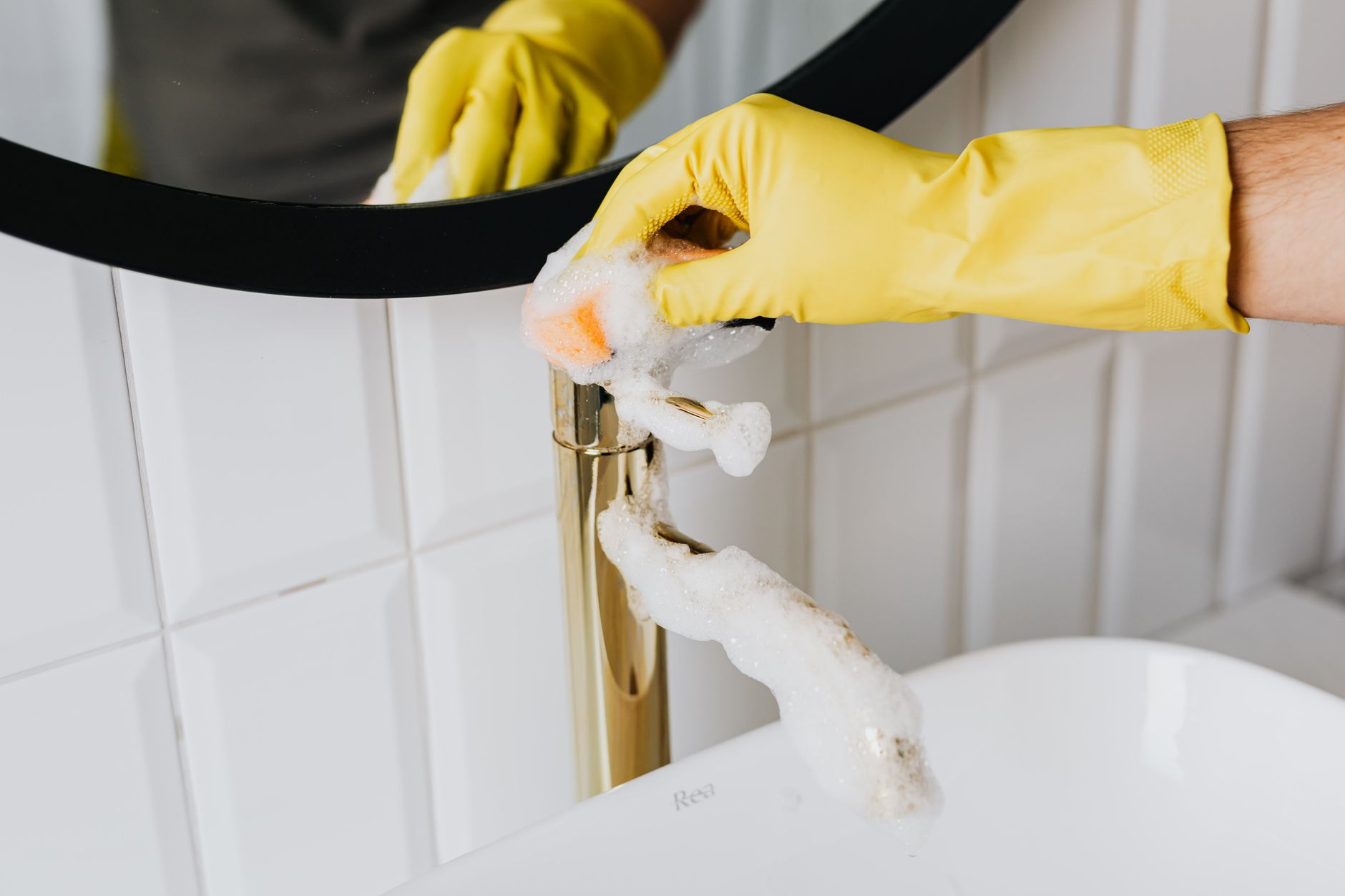 A person cleaning a bathroom