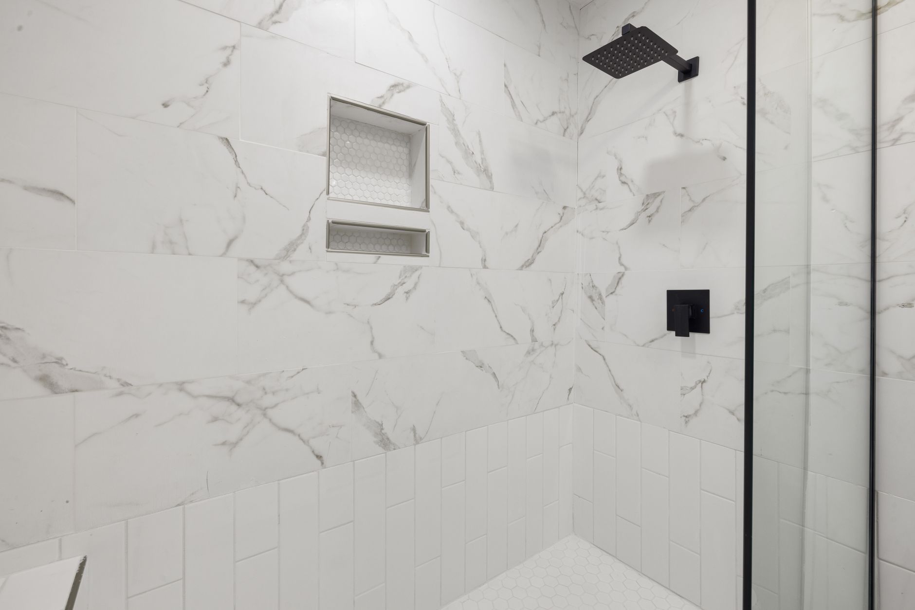 A bright white bathroom with a shower