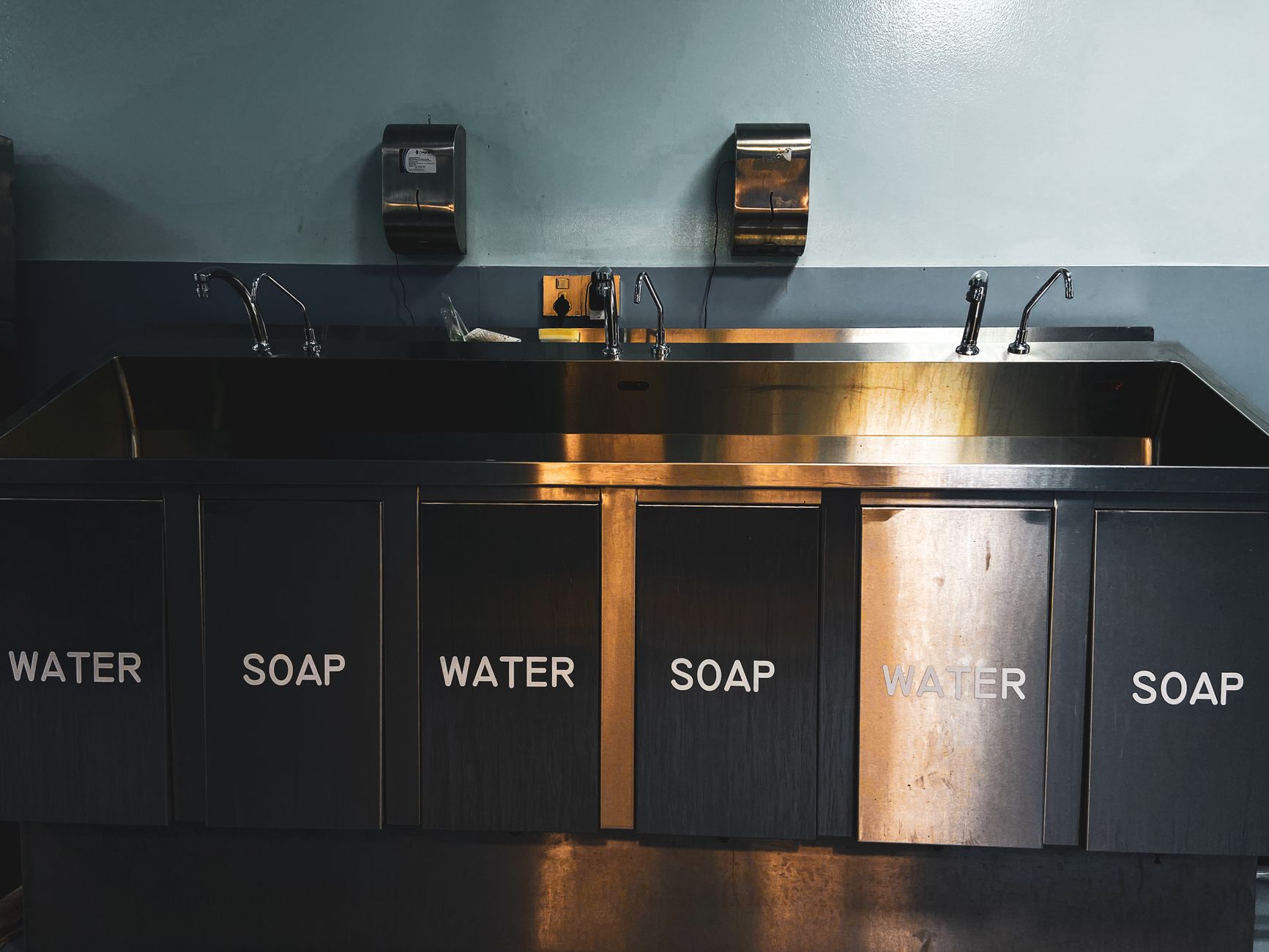 A row of stainless steel sinks