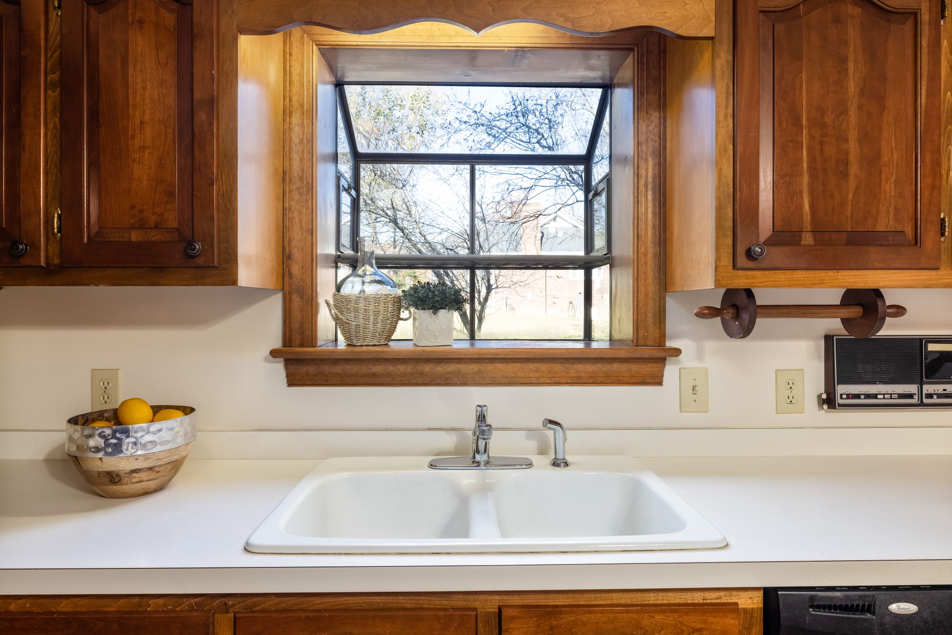 A white double sink under a window