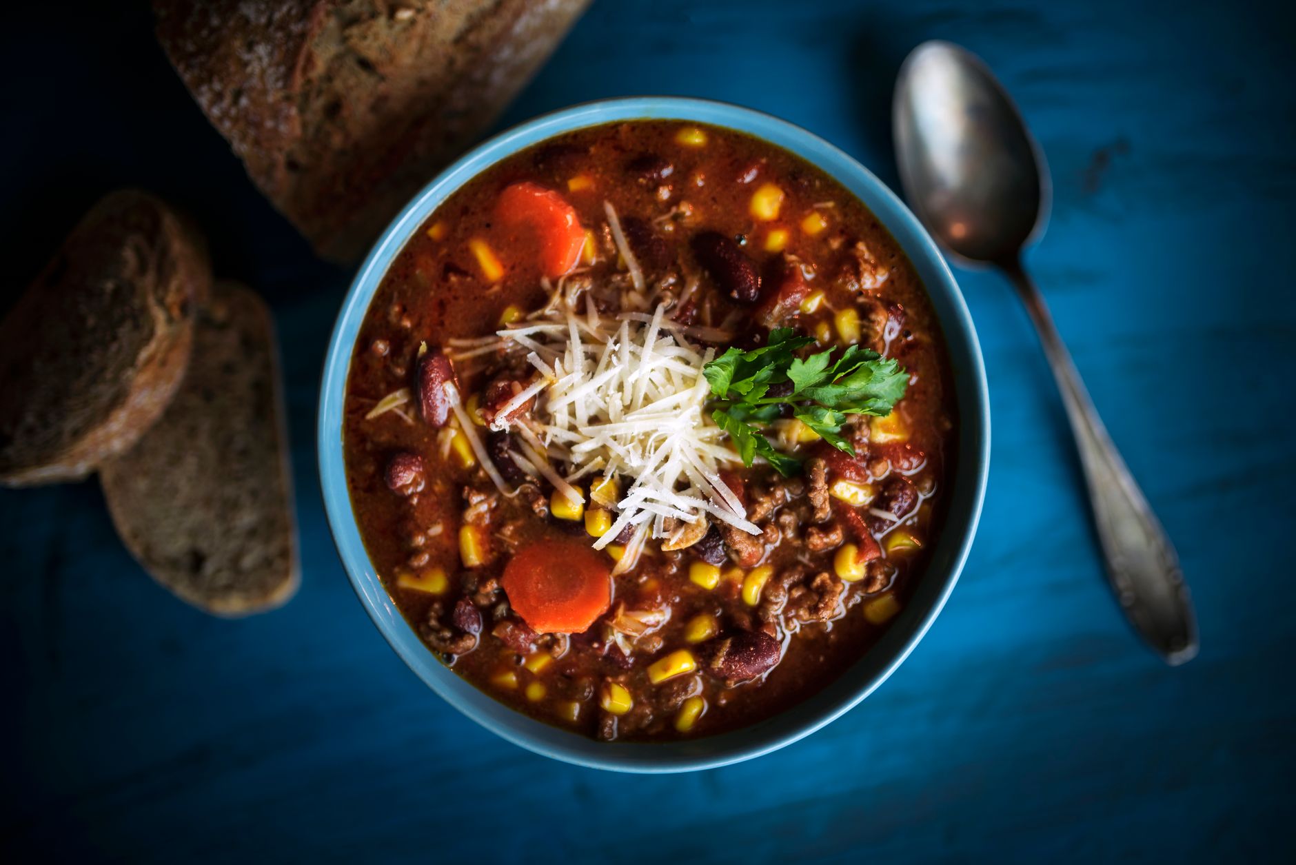 A bowl of chili served at a dinner table