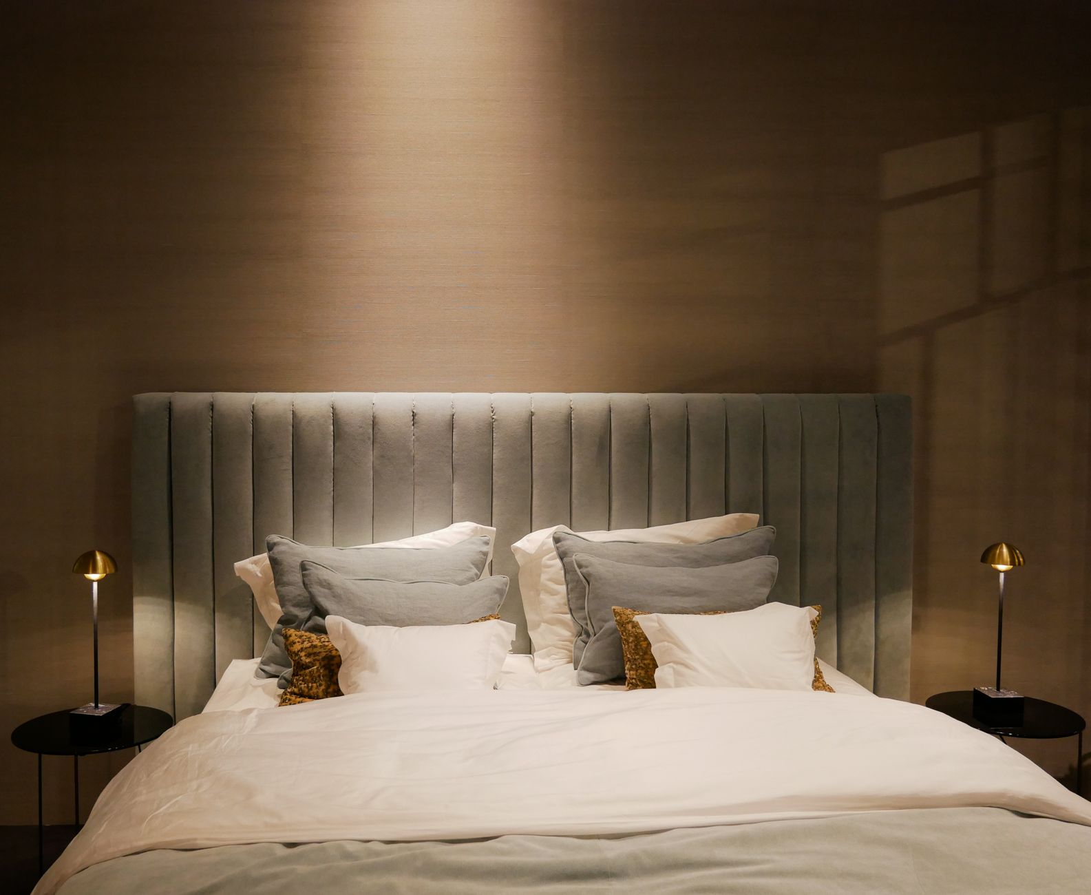 A bed lit by two bedside lamps