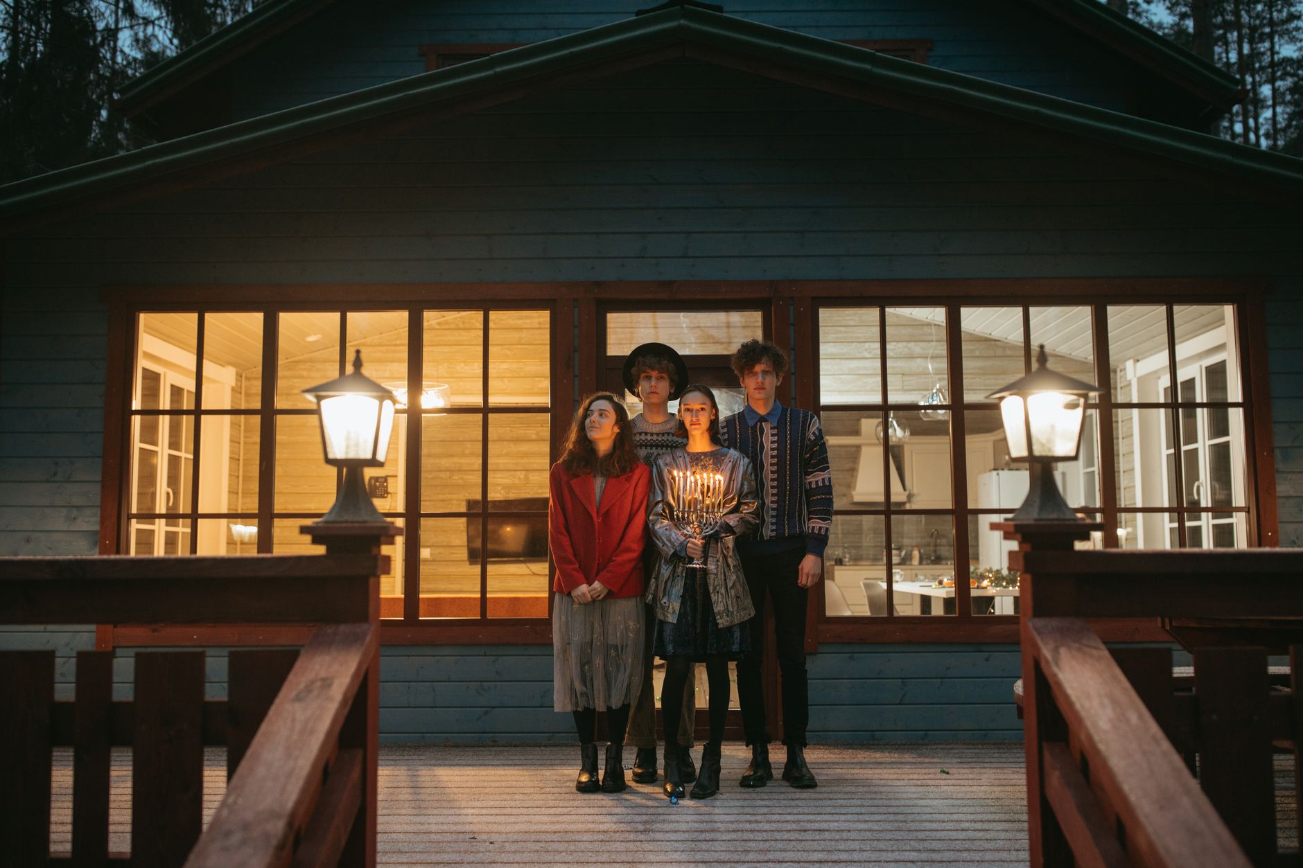 A family on a lit porch in the evening