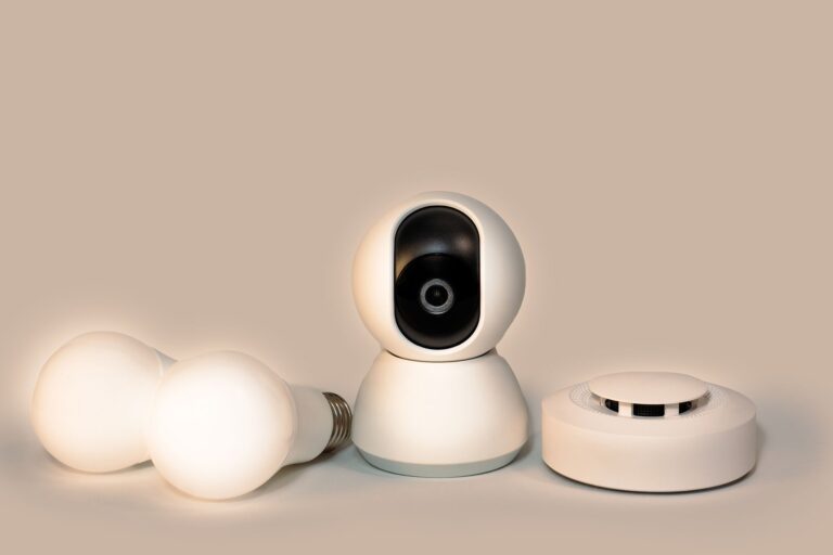Best smoke detector: a smoke detector beside smart bulbs and a camera