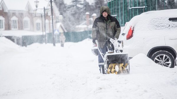 Best snow blower: a man clearing a snowy street with a snow blower