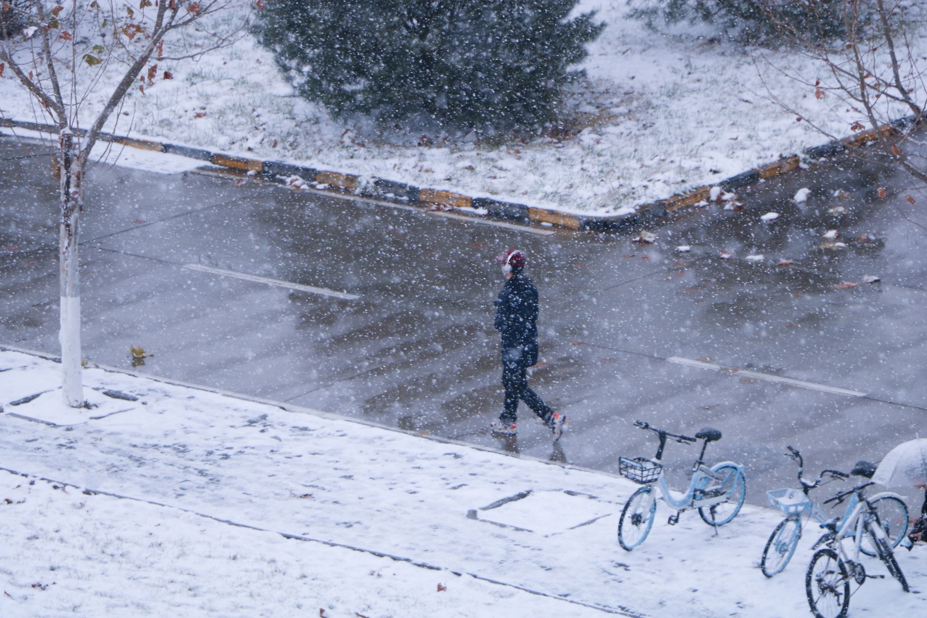 A person walking on a snowy sidewalk