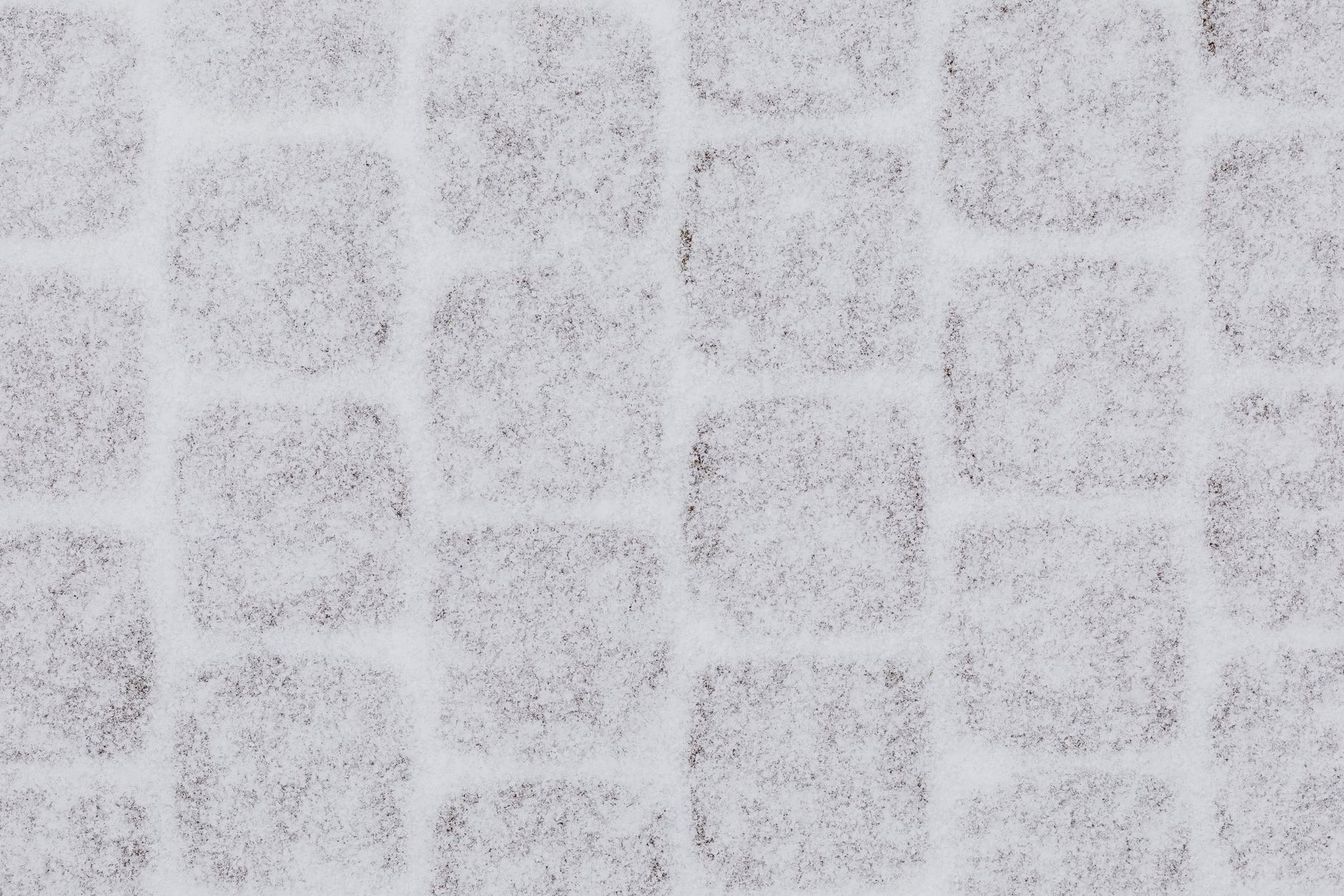 Fresh snow dusting paving stones