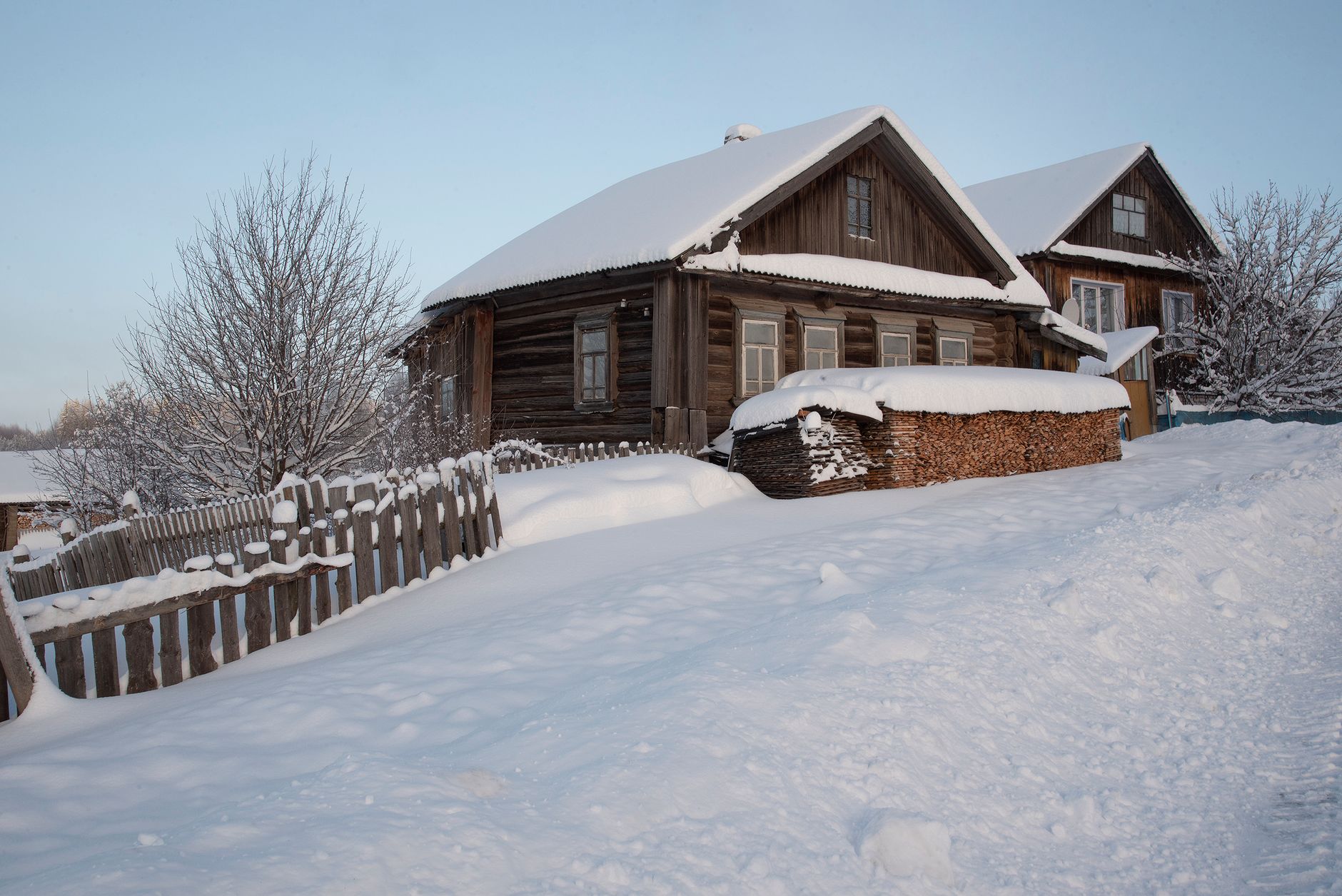 Snow-covered wooden houses on a winter day