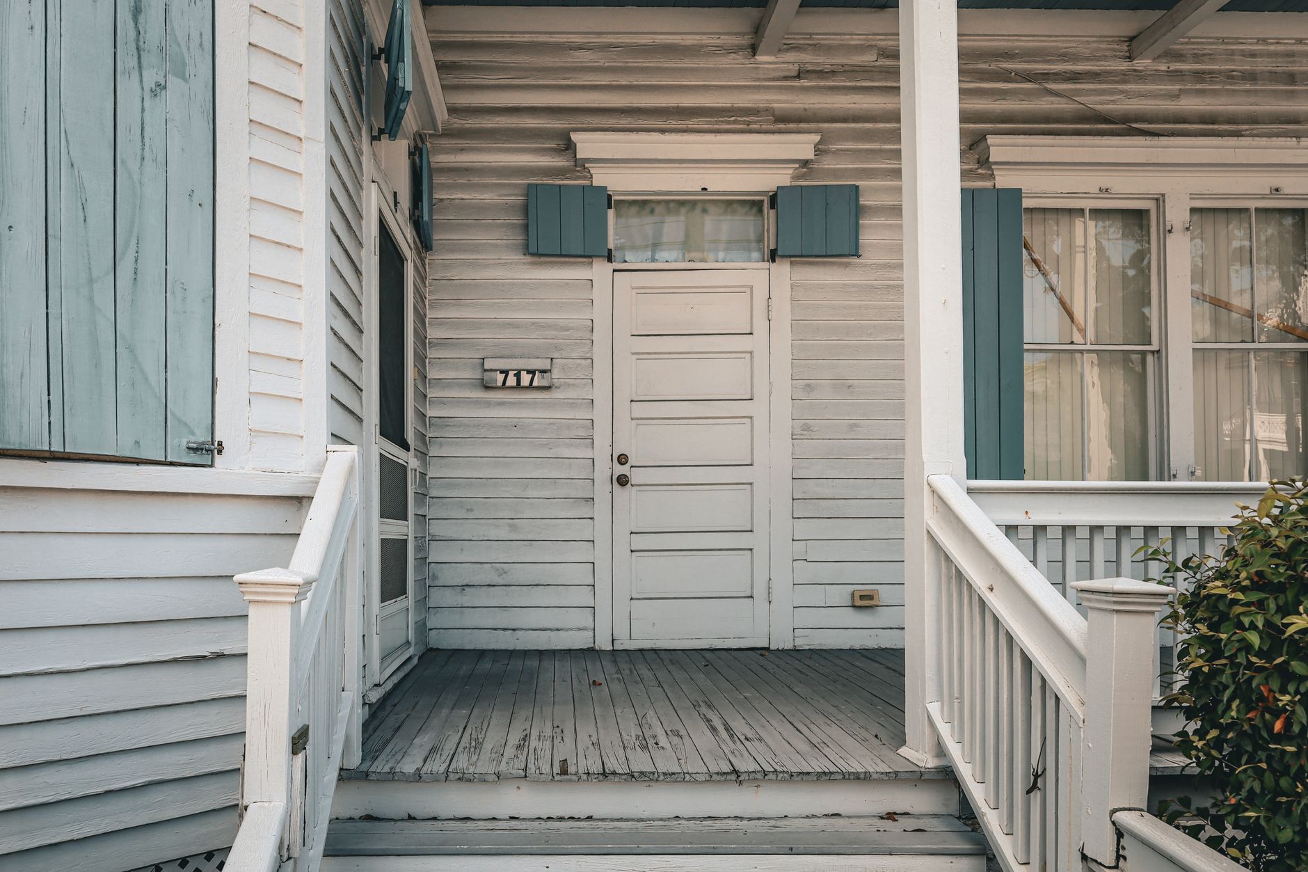 Front porch steps leading to a white house