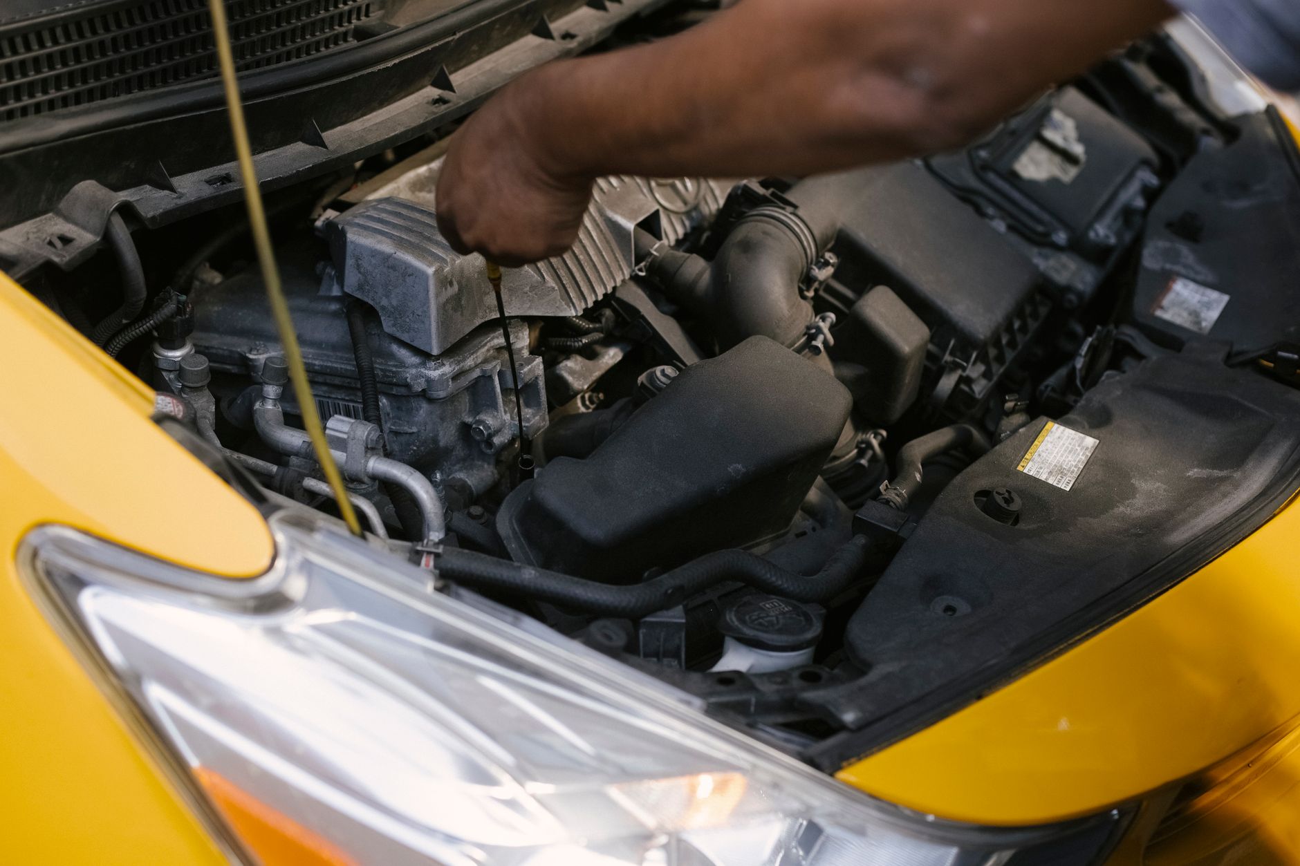 Hands working on a car engine