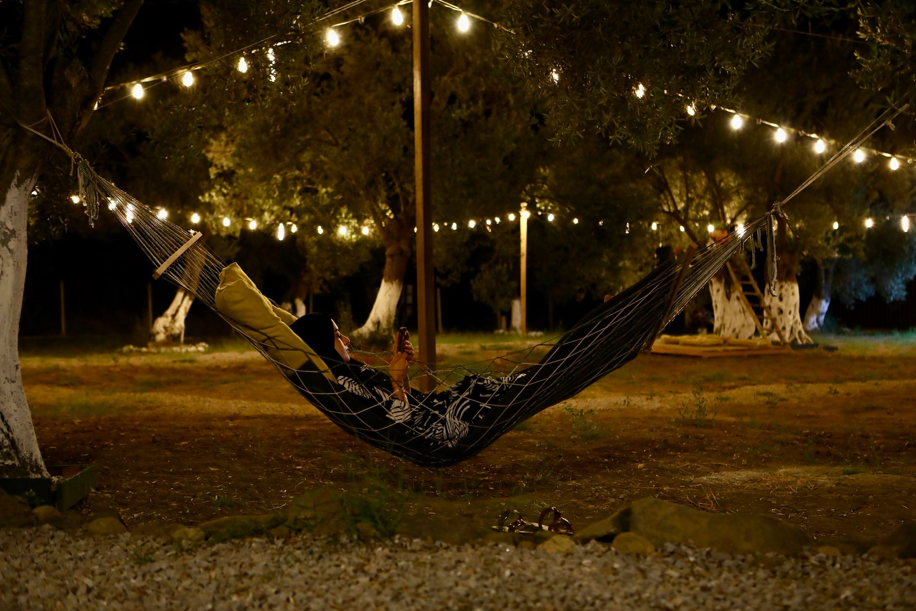 String lights over a backyard patio in the evening