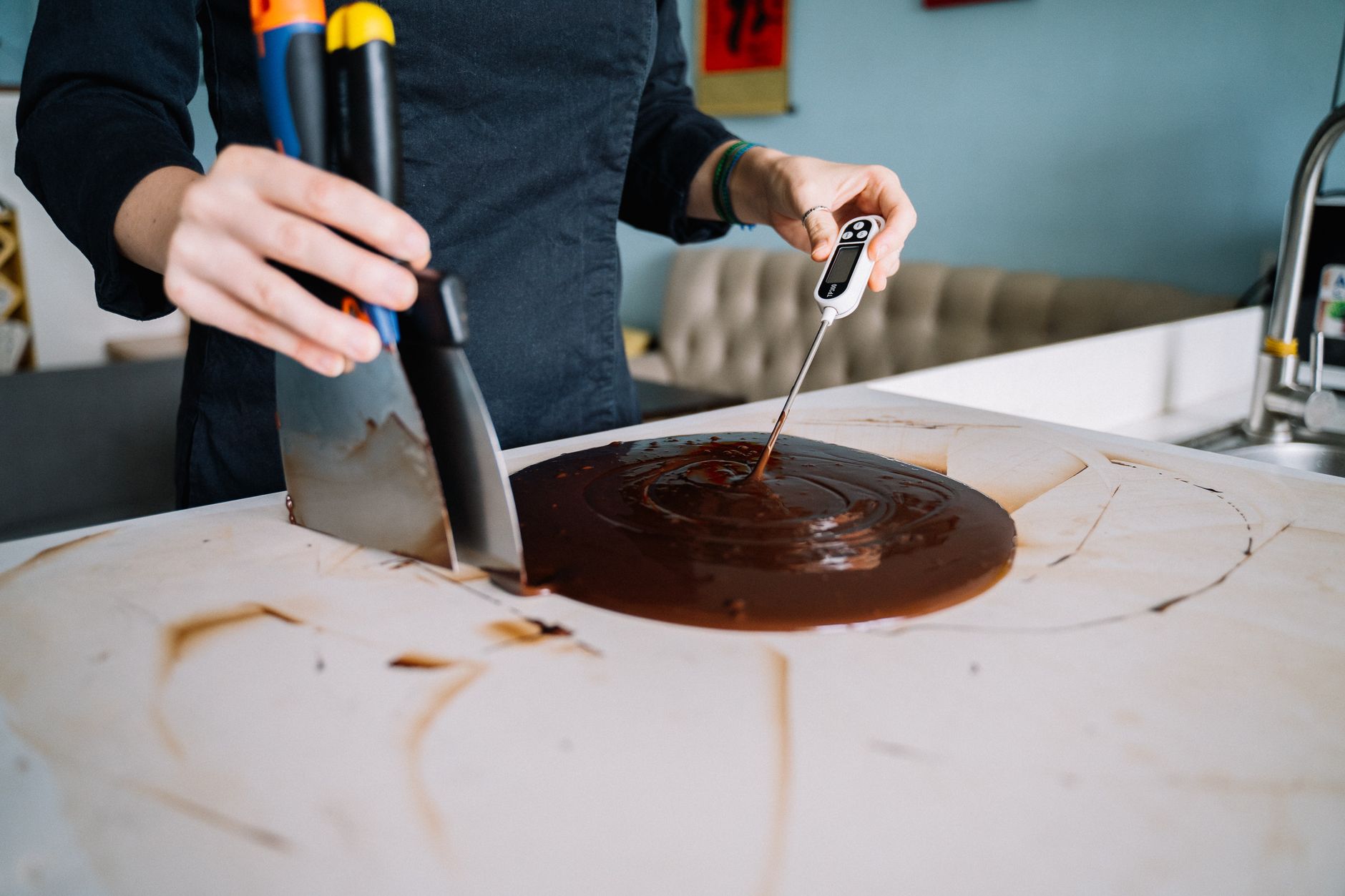 Checking chocolate with a thermometer