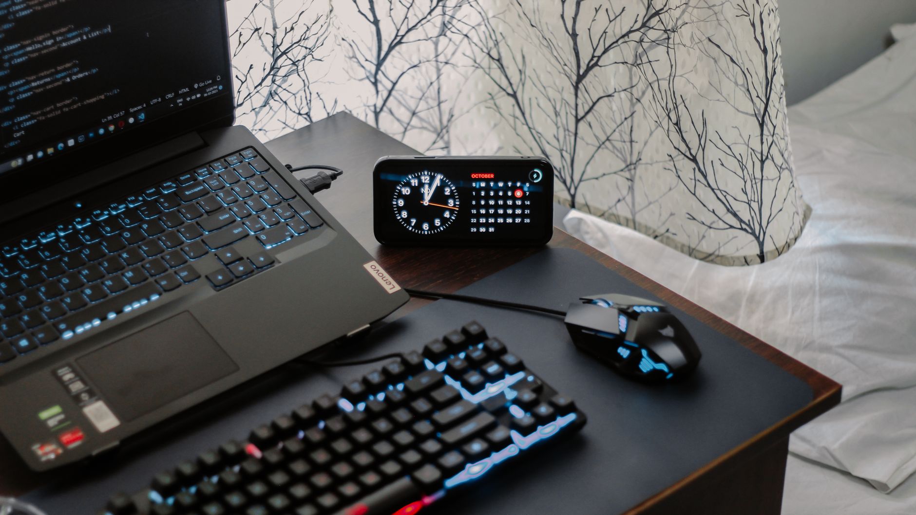 A laptop and desk clock on a desk